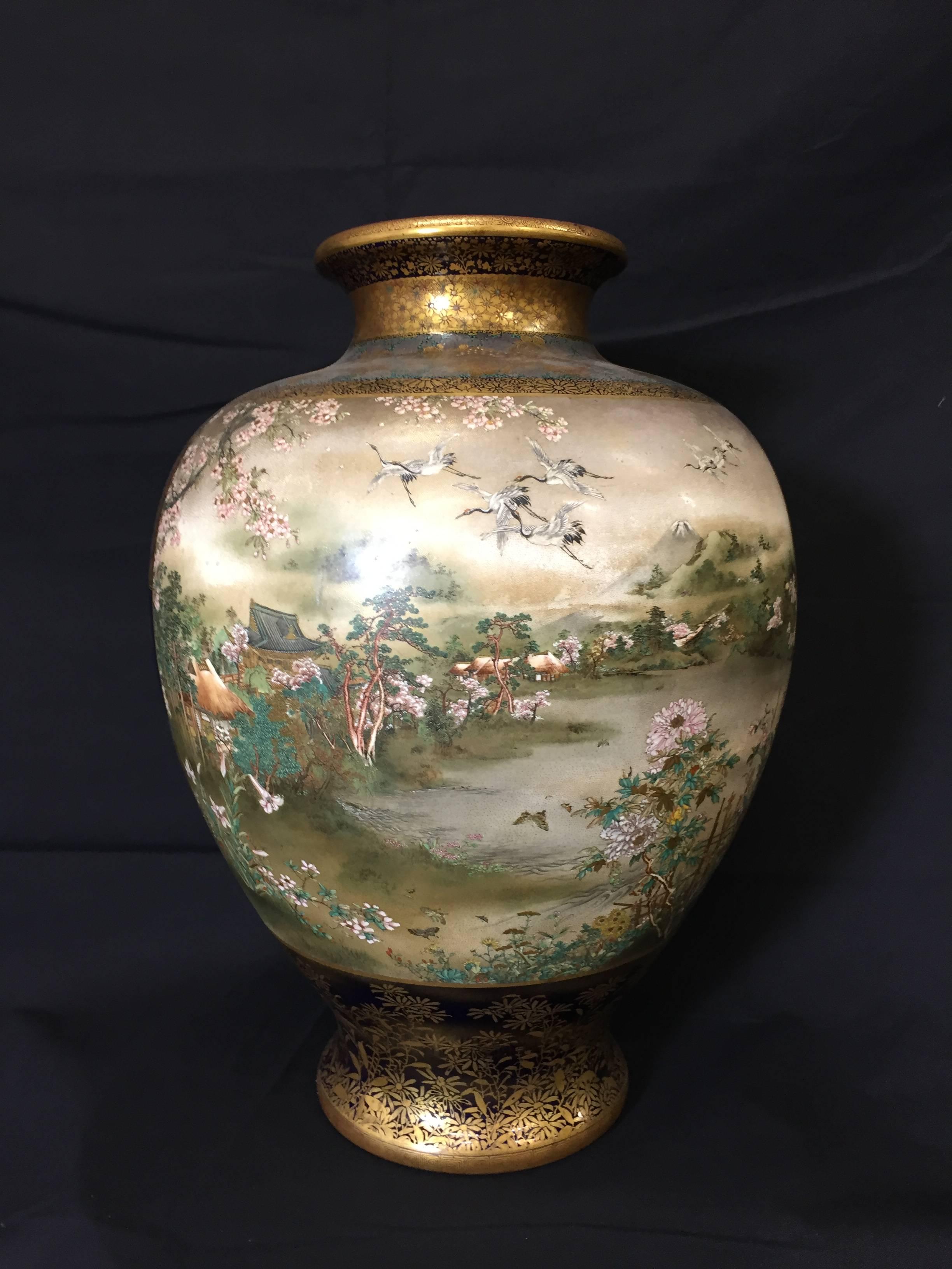 A very fine quality Japanese Satsuma vase by Kinkozan zo. Meiji period late 19th Century.
Decorated in various coloured enamels and gilt, the two panels depicting ladies and children amongst trees and flowers, bordered by cherry blossoms and maple