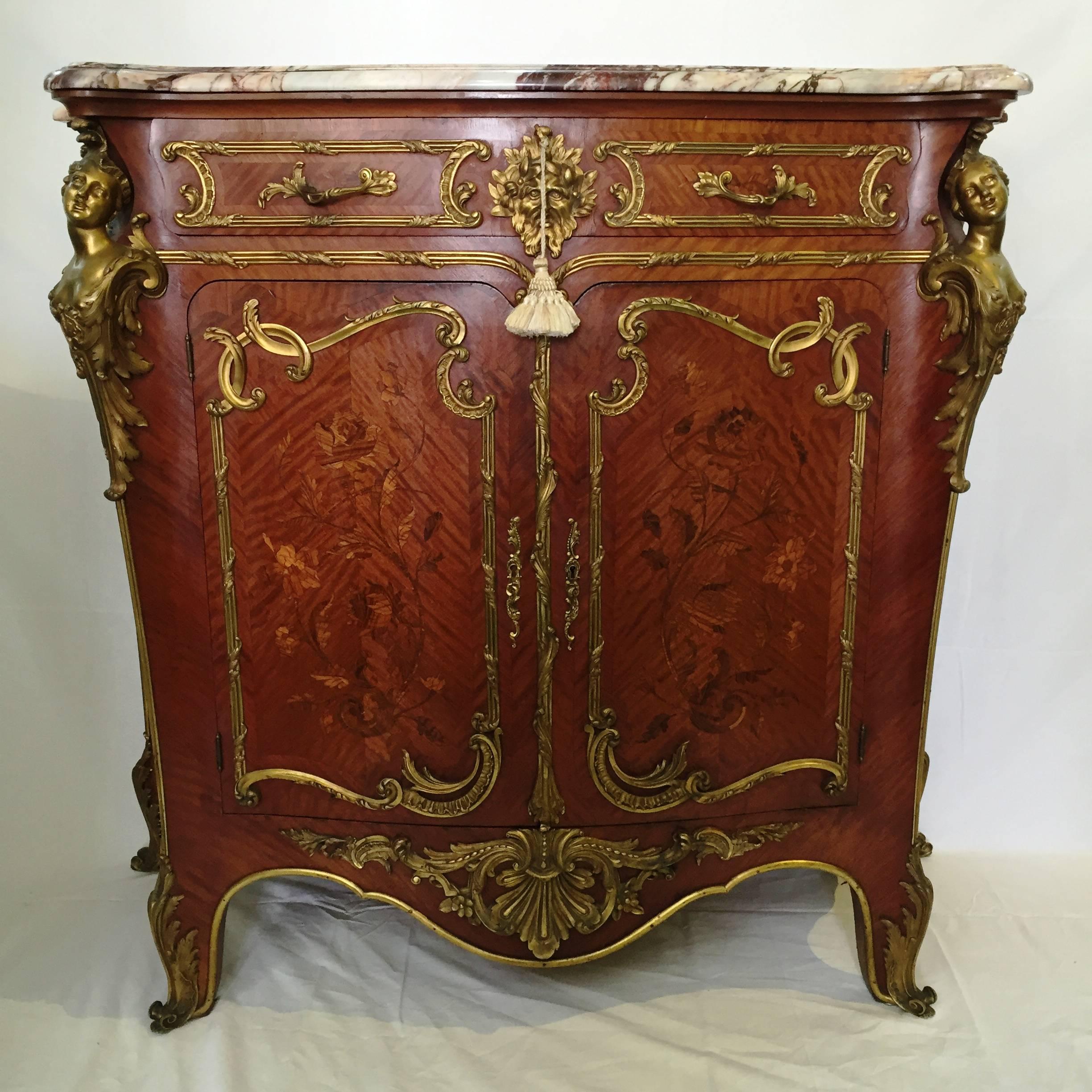 A superb and rare pair of Louis XV style kingwood ormolu-mounted side cabinets having the original breche marble tops, wonderful marquetry inlaid panels to the doors and sides. Scrolling ormolu mounts, mythical masks to the drawer fronts and