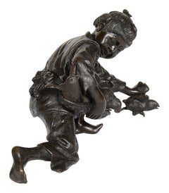 Japanese bronze girl, gathering up chickens. circa 1890.