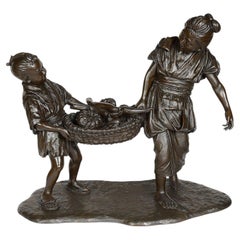 Japanese bronze mother + child carrying fruit