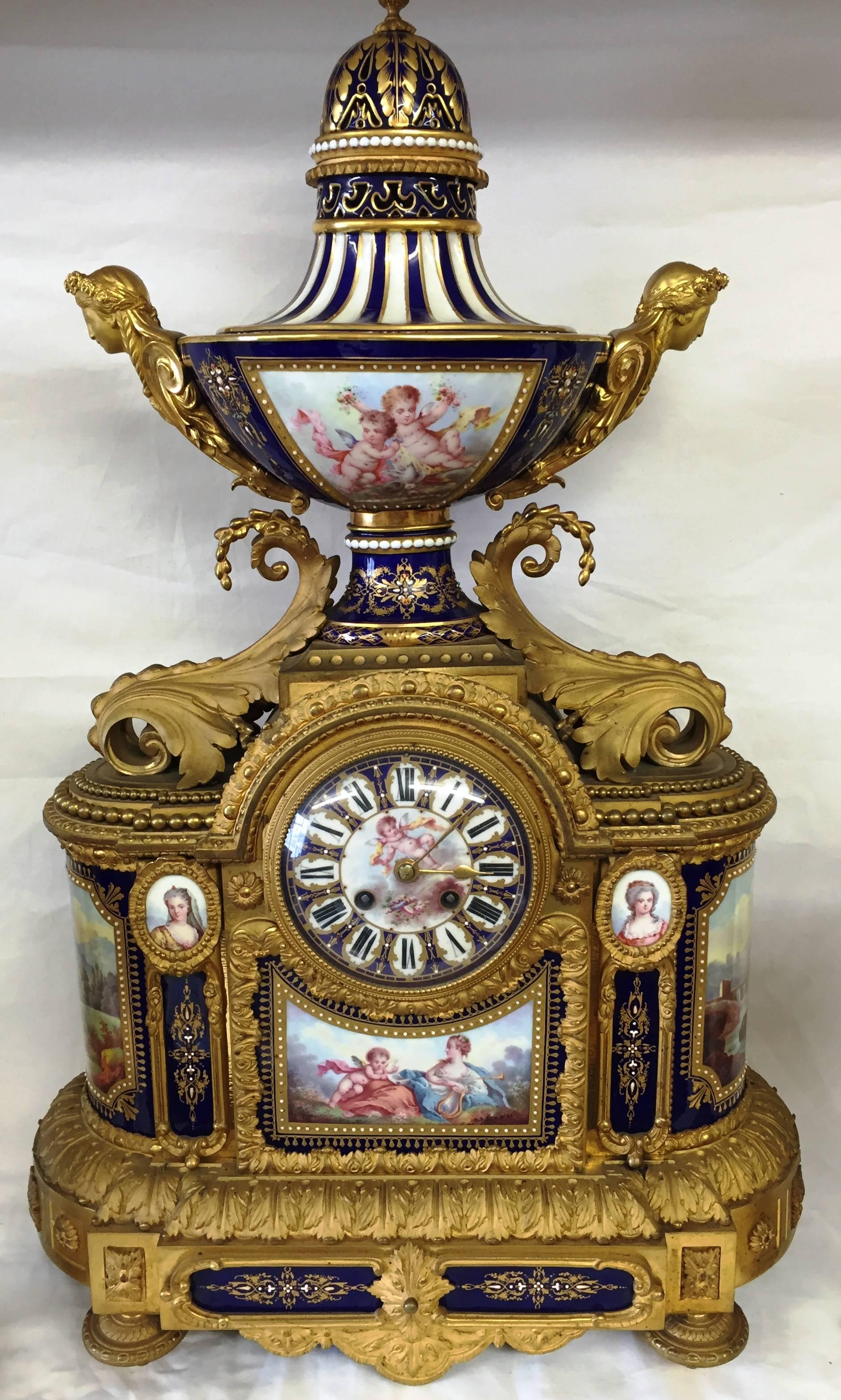 A fine quality 19th century French Sevres porcelain and gilded ormolu clock garniture. Having a very impressive pair of five branch candelabra each with urns depicting romantic scenes, a pair of lidded urns and this wonderful clock to the center.
