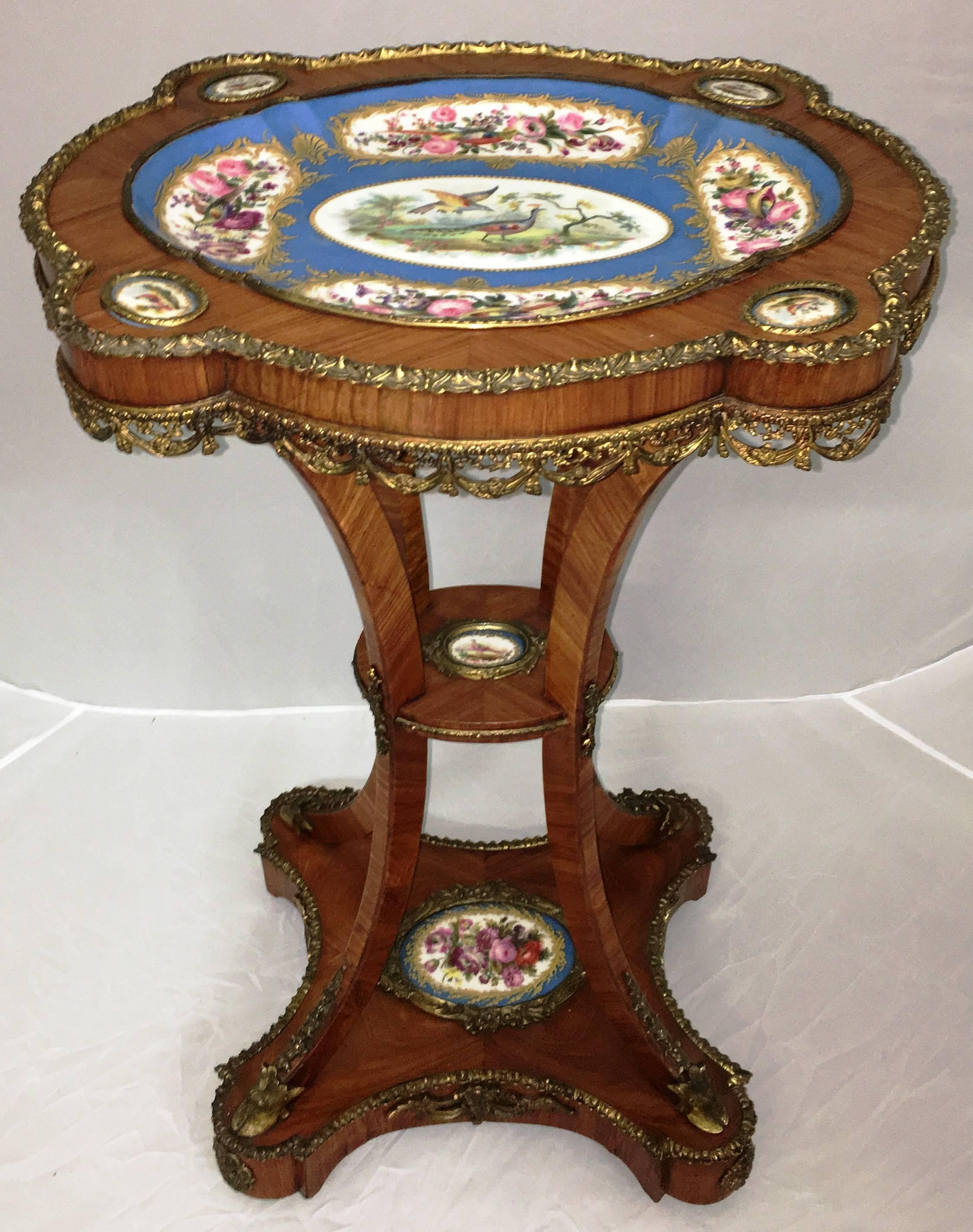 A very good quality near pair of French kingwood veneered, ormolu-mounted side tables, having 'Sevres porcelain plaques mounted and raised on out swept legs and a plinth base.