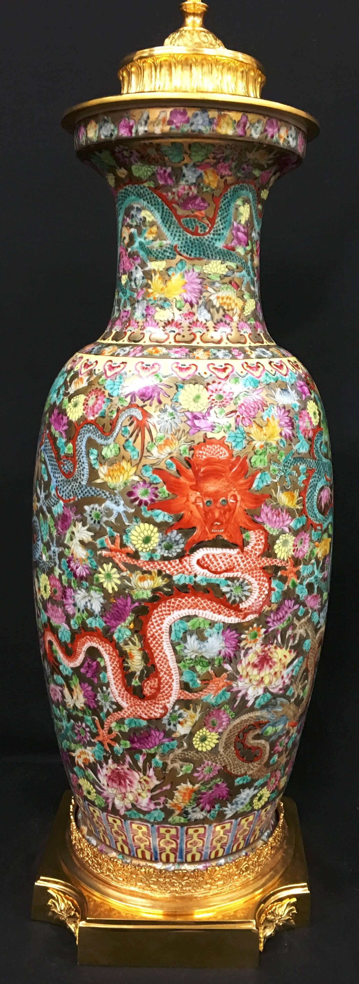 A very impressive 19th century Chinese famille rose vase/lamp. Having fine hand-painted decoration, depicting flowers and foliage with mythical dragons amongst them and gilded ormolu mounts to the top and base.