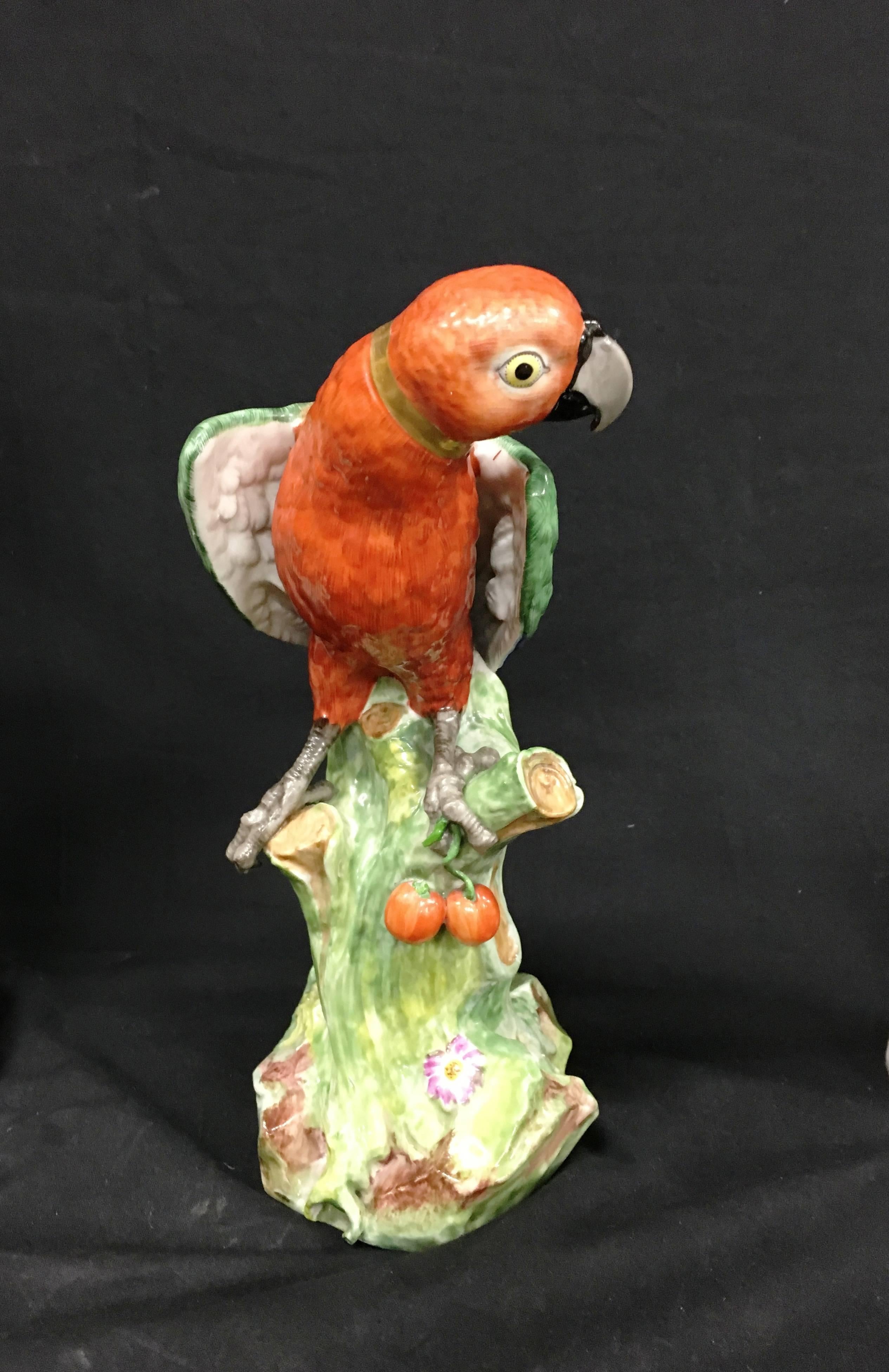 A striking 19th century Meissen style Sason porcelain parrot, having wonderful bold colors and mounted on a tree stump.