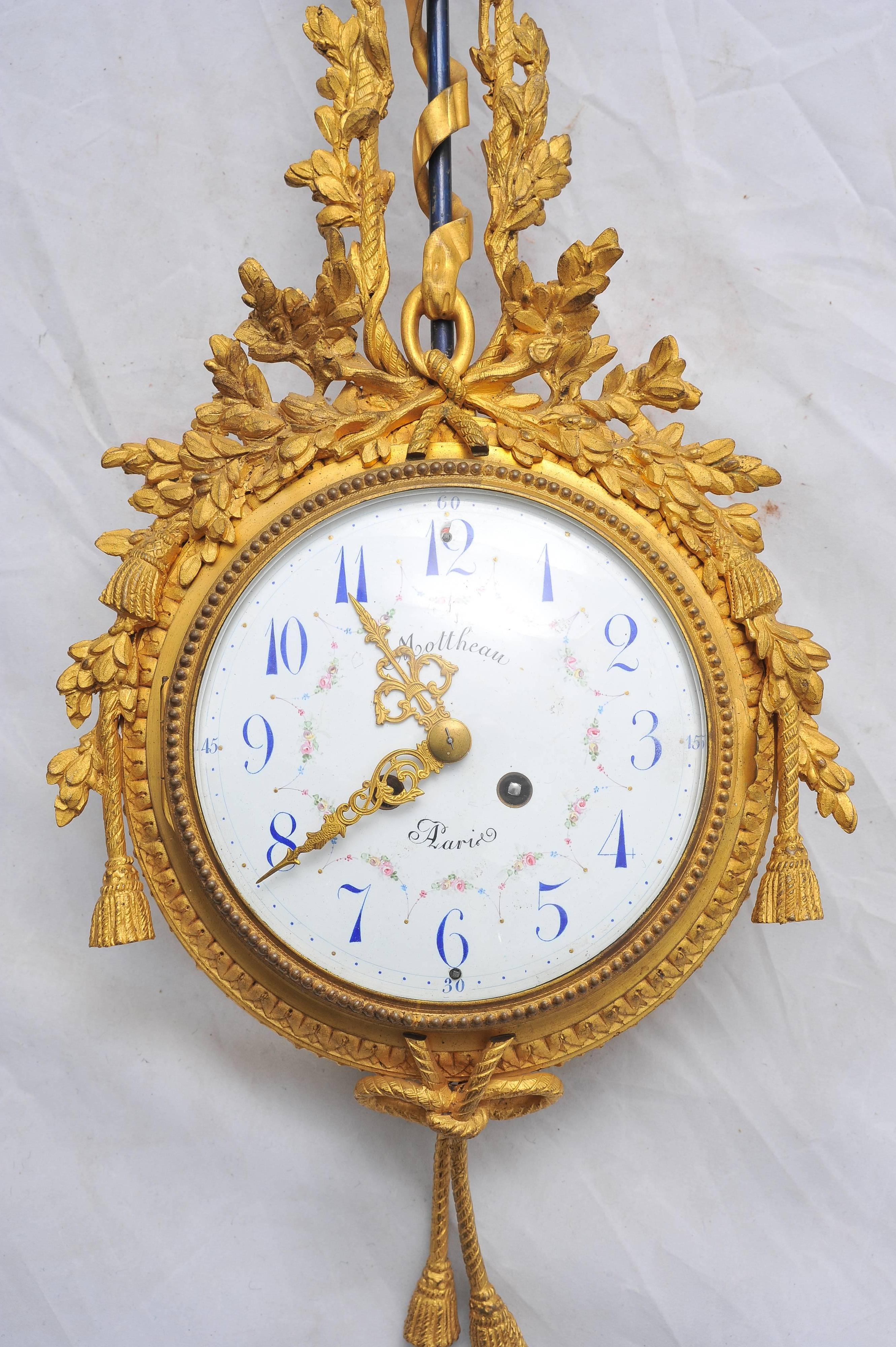 A very pleasing late 19th century gilded ormolu wall clock. Having gilded foliate, ribbon and swag decoration. The white enamel clock face having an eight day chiming movement and signed

Moetheau, Paris.