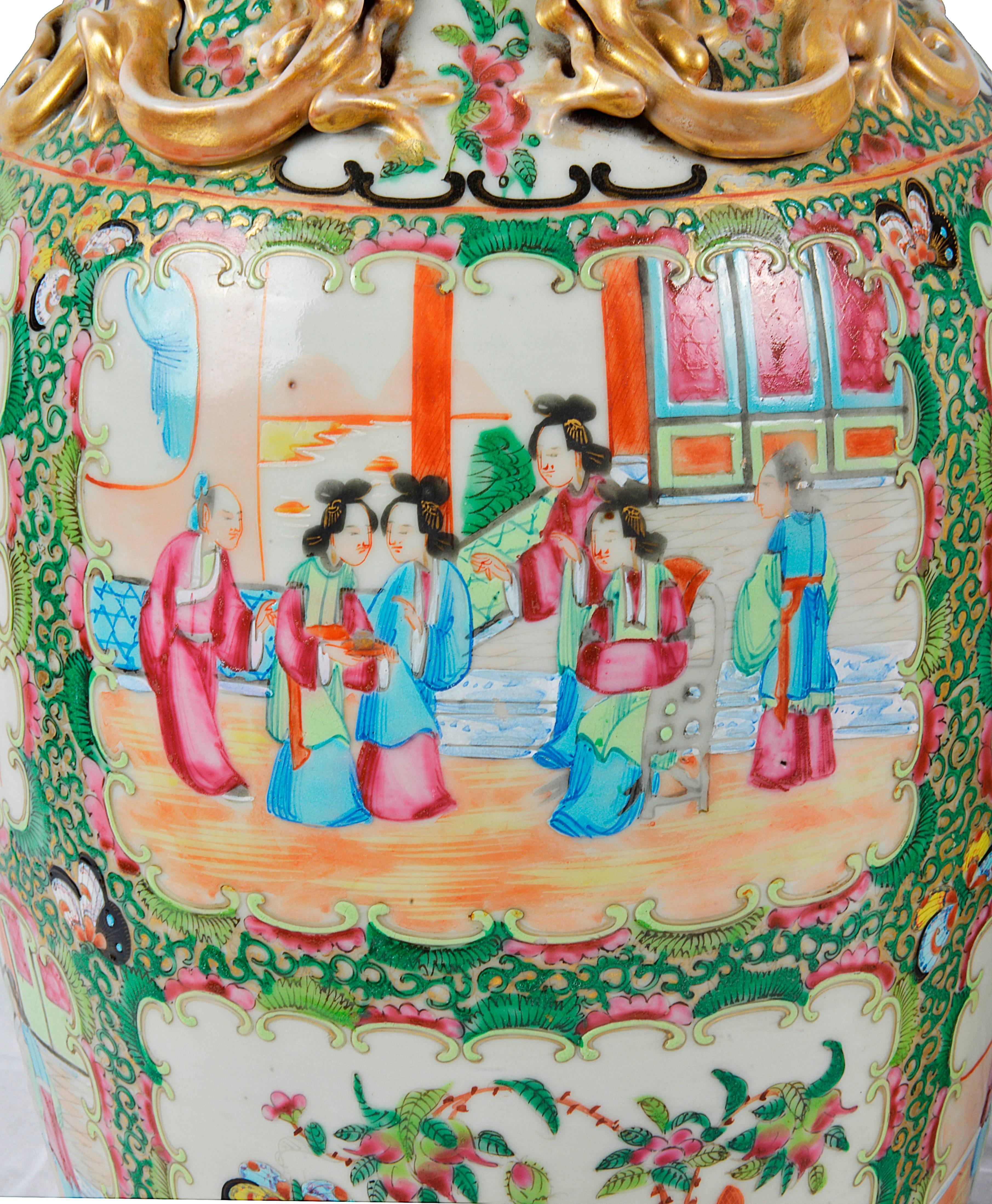 A good quality pair of 19th century Chinese canton rose medallion vases. Each having panels of classical hand-painted scenes of women meeting in the gardens. The surround in a light green foliage design, birds and flowers and butterflies.