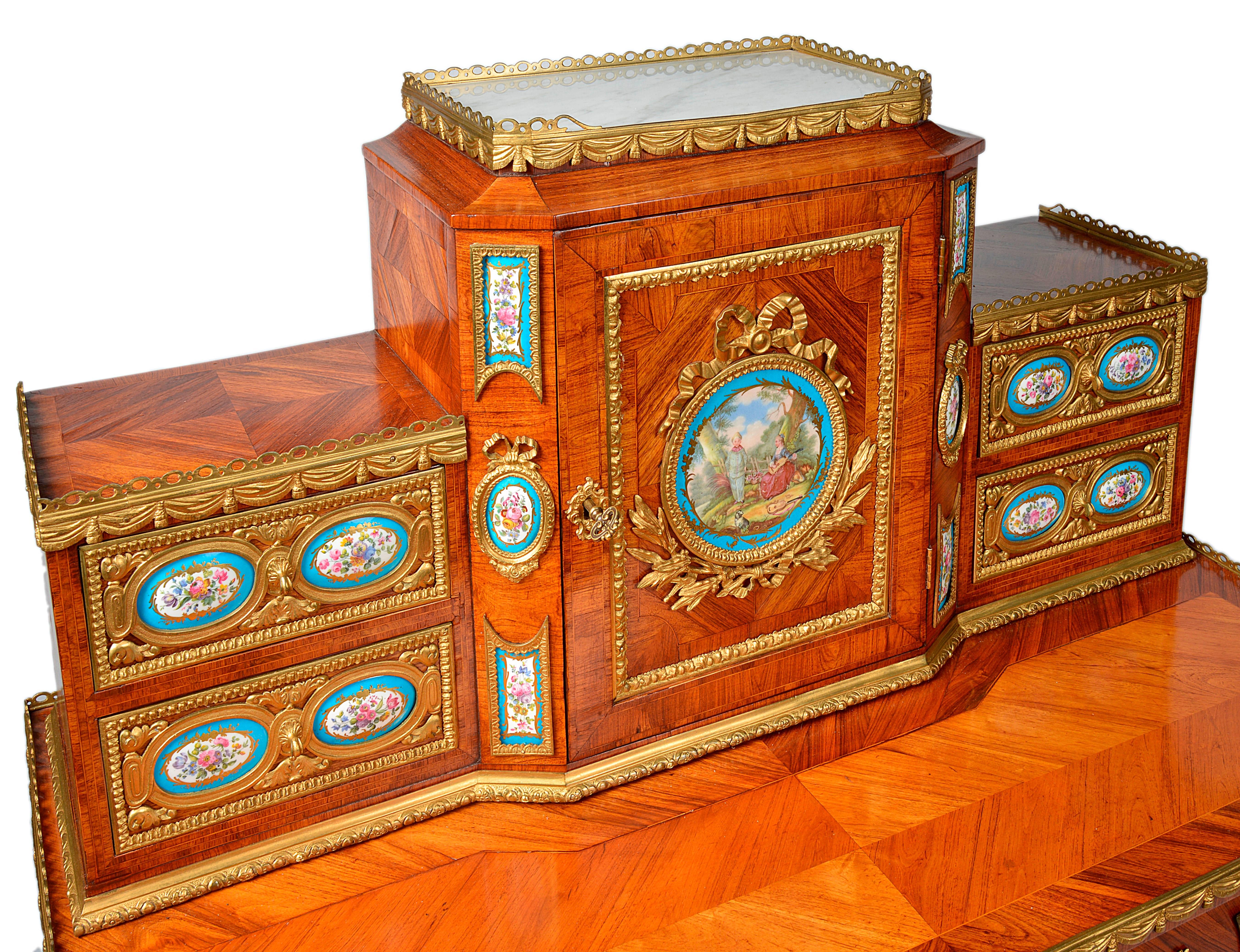 A very good quality French 19th century Louis XVI style kingwood, ormolu-mounted Bonheur Du Jour. Having numerous Sevres plaques to the drawer and door fronts. A large single frieze drawer, raised on ormolu-mounted cabriole legs.