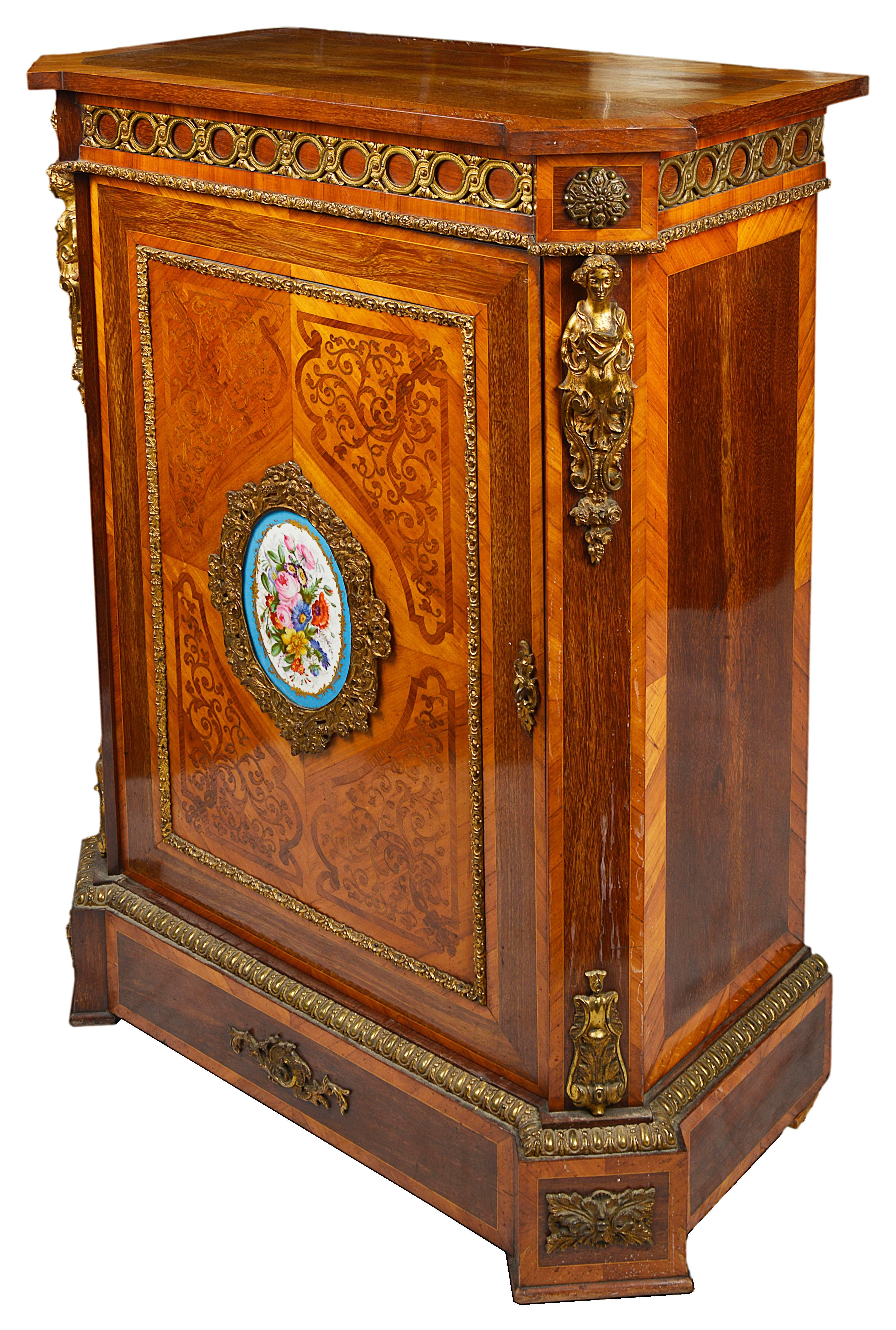 A fine quality 19th century seaweed marquetry inlaid Pier cabinet, having gilded ormolu mounts and a 'Sevres' porcelain plaque to the center of the door.
The door opening to reveal a single shelf within.