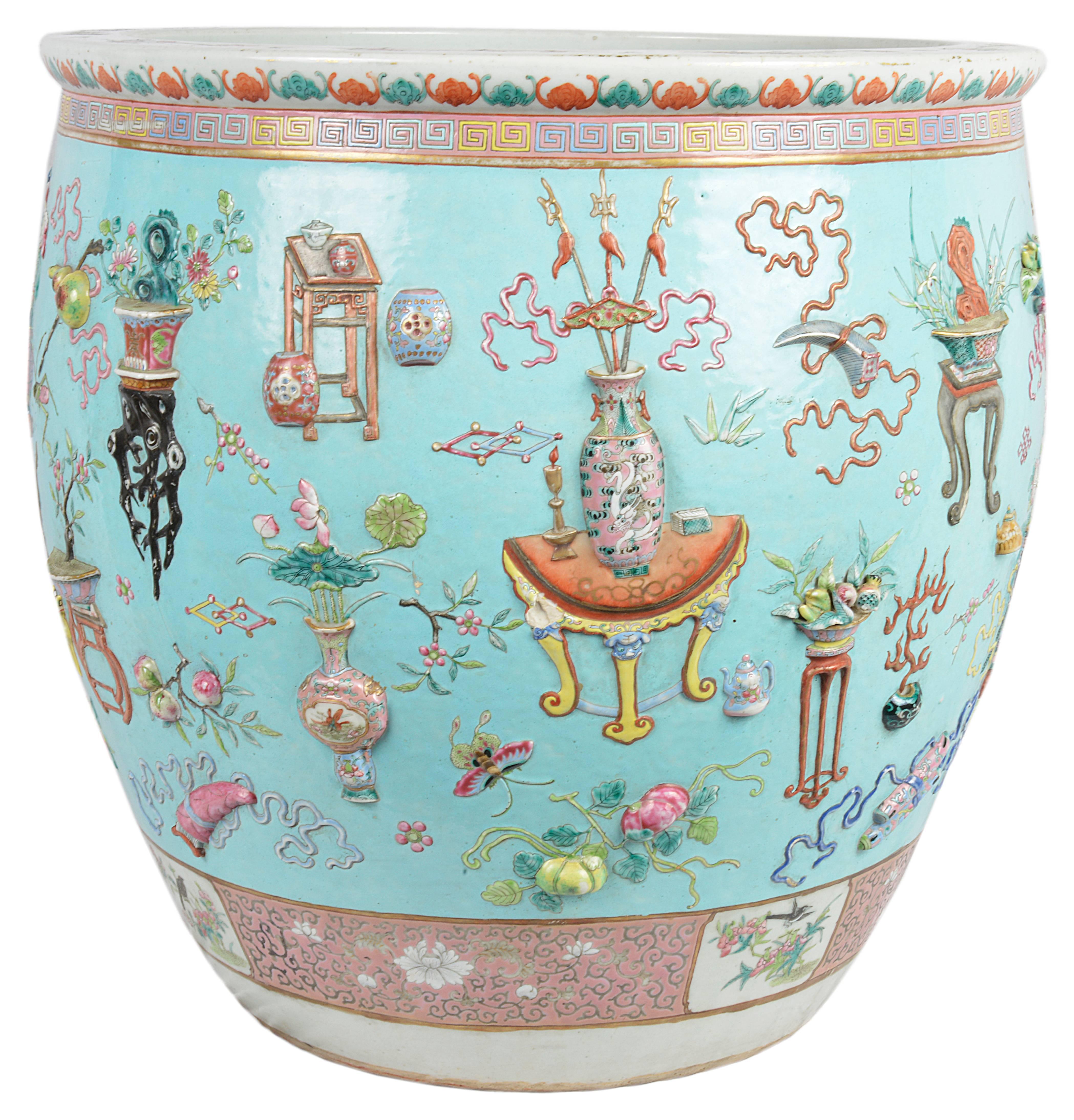 Very good quality 19th century Chinese Famille Rose fish bowl. Having a wonderful selection of raised, hand-painted vases, lanterns, furniture, flowers and motifs set on a turquoise back ground and a pink patterns boarder top and bottom. The