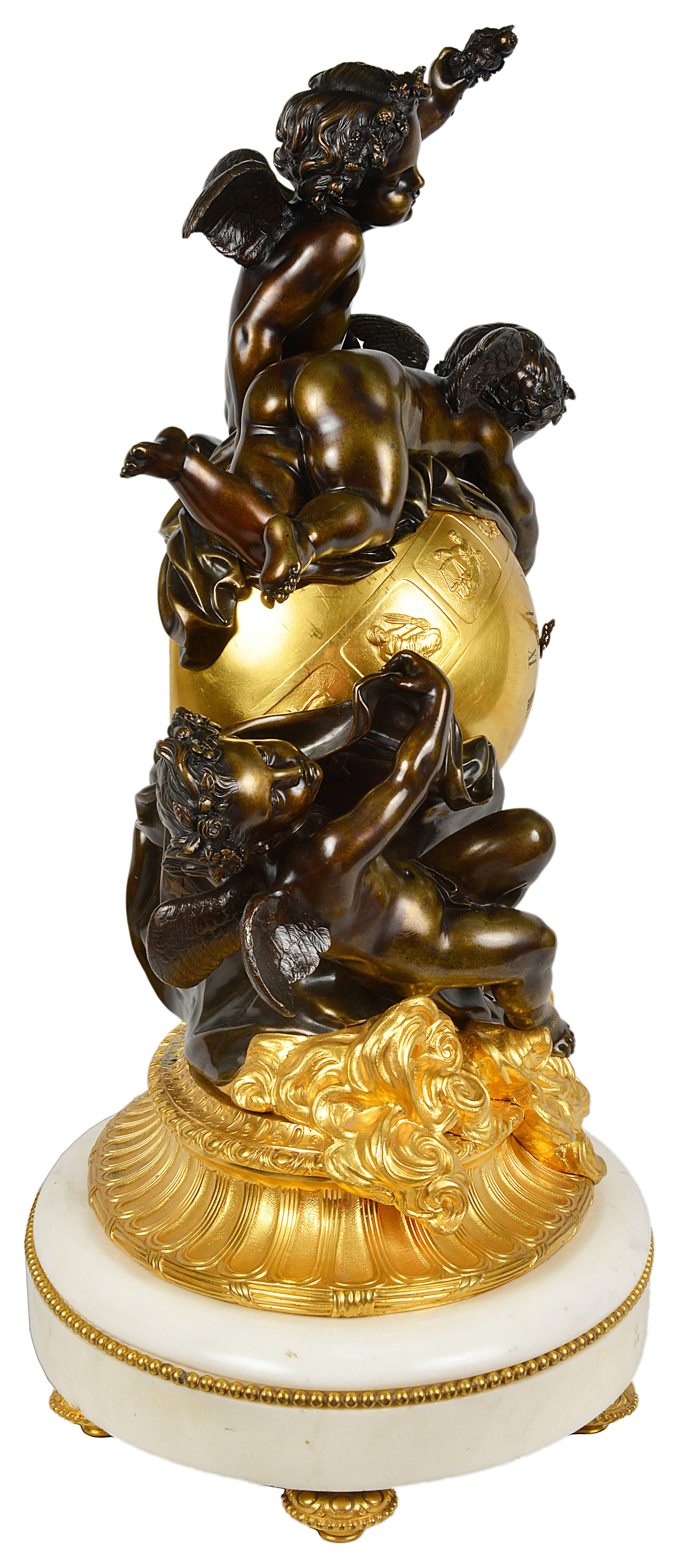 A very impressive 19th century, French, Louis XVI style mantel clock. Depicting bronze cherubs around the orb clock, having an eight day striking movement, signs of the zodiac around the face and gilded waves to the base then mounted on a white