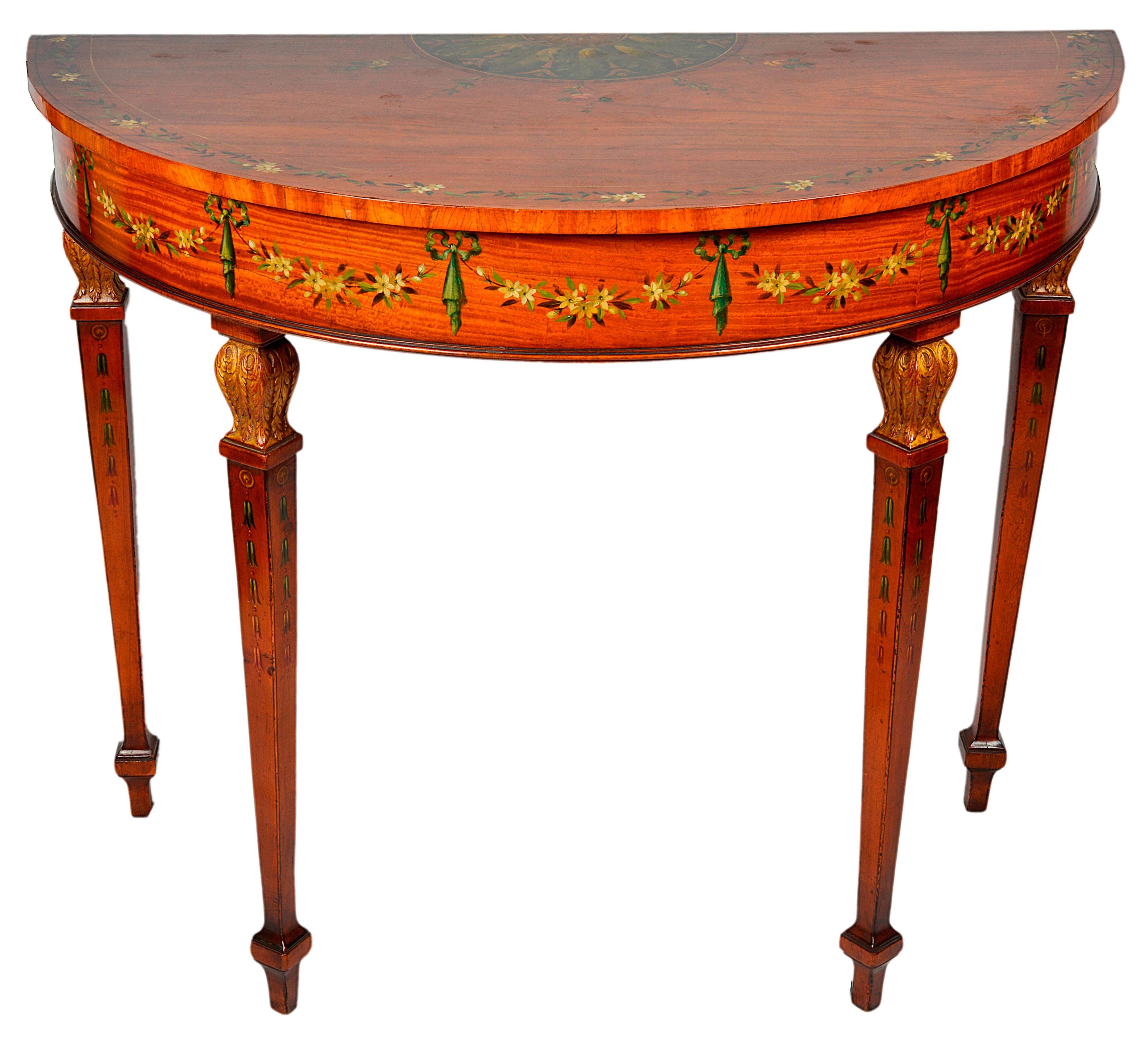 A good quality pair of Edwardian period Sheraton Revival satinwood console tables, each having classical painted decoration and raised on square tapering legs.