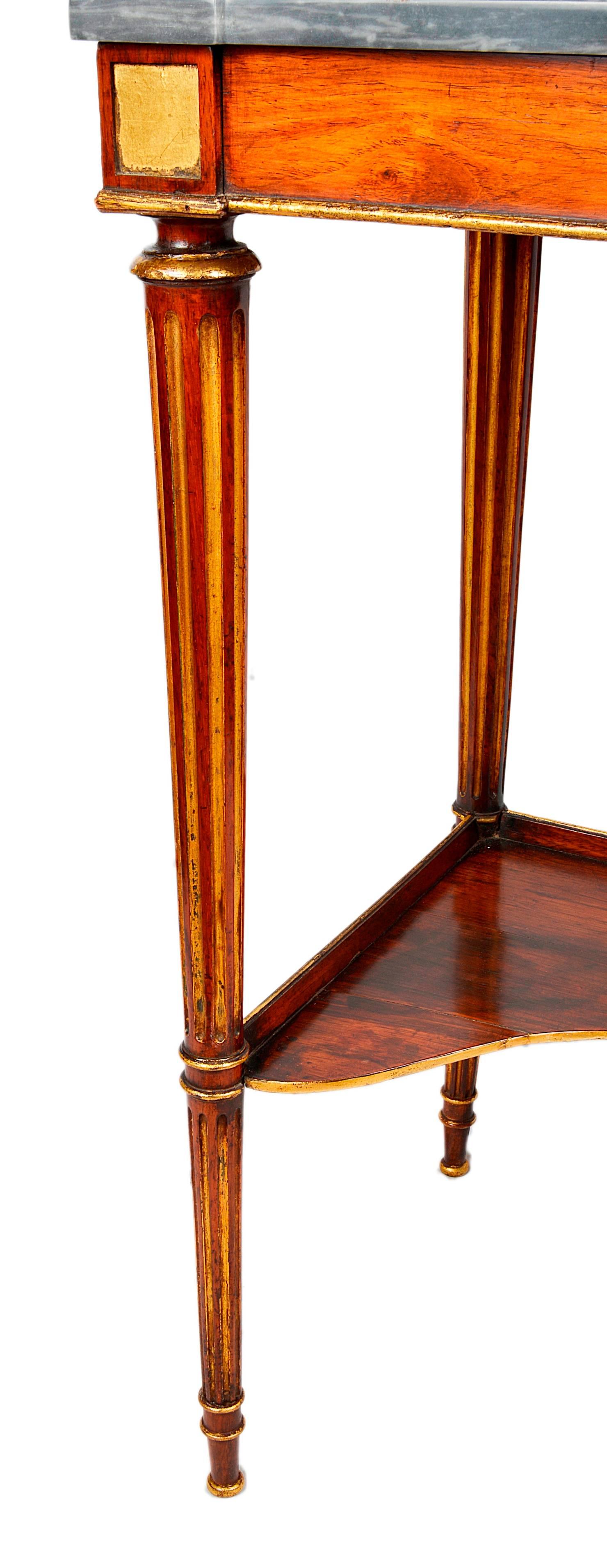 A good quality regency period rosewood and parcel-gilt side table, having its original grey veined marble top, raised on turned tapering fluted legs, united by a shelf beneath.