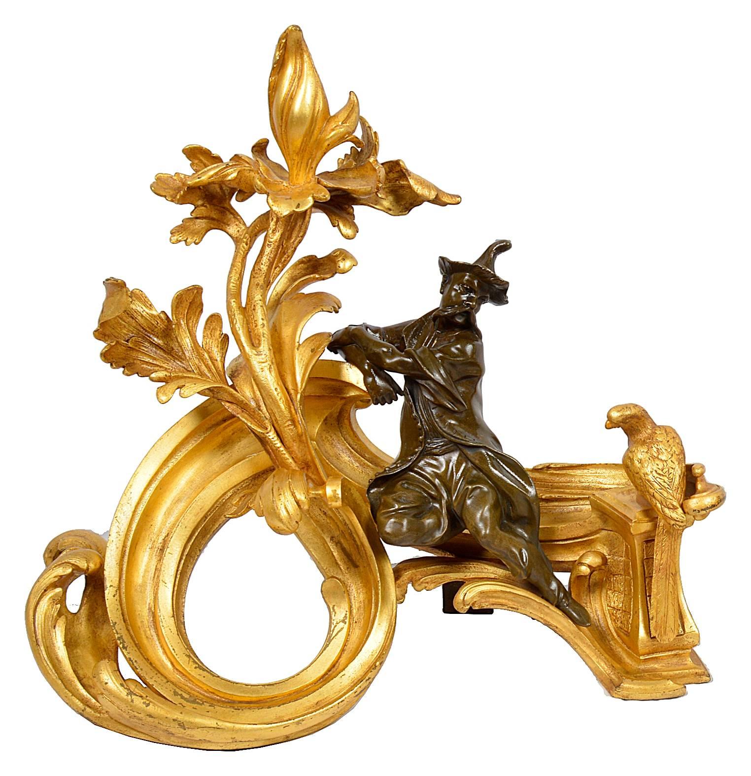 A very decorative and stylish pair of French gilded ormolu and bronze patinated chenets (fire dogs) depicting a China man and women resting on scrolling foliate with doves on either end.