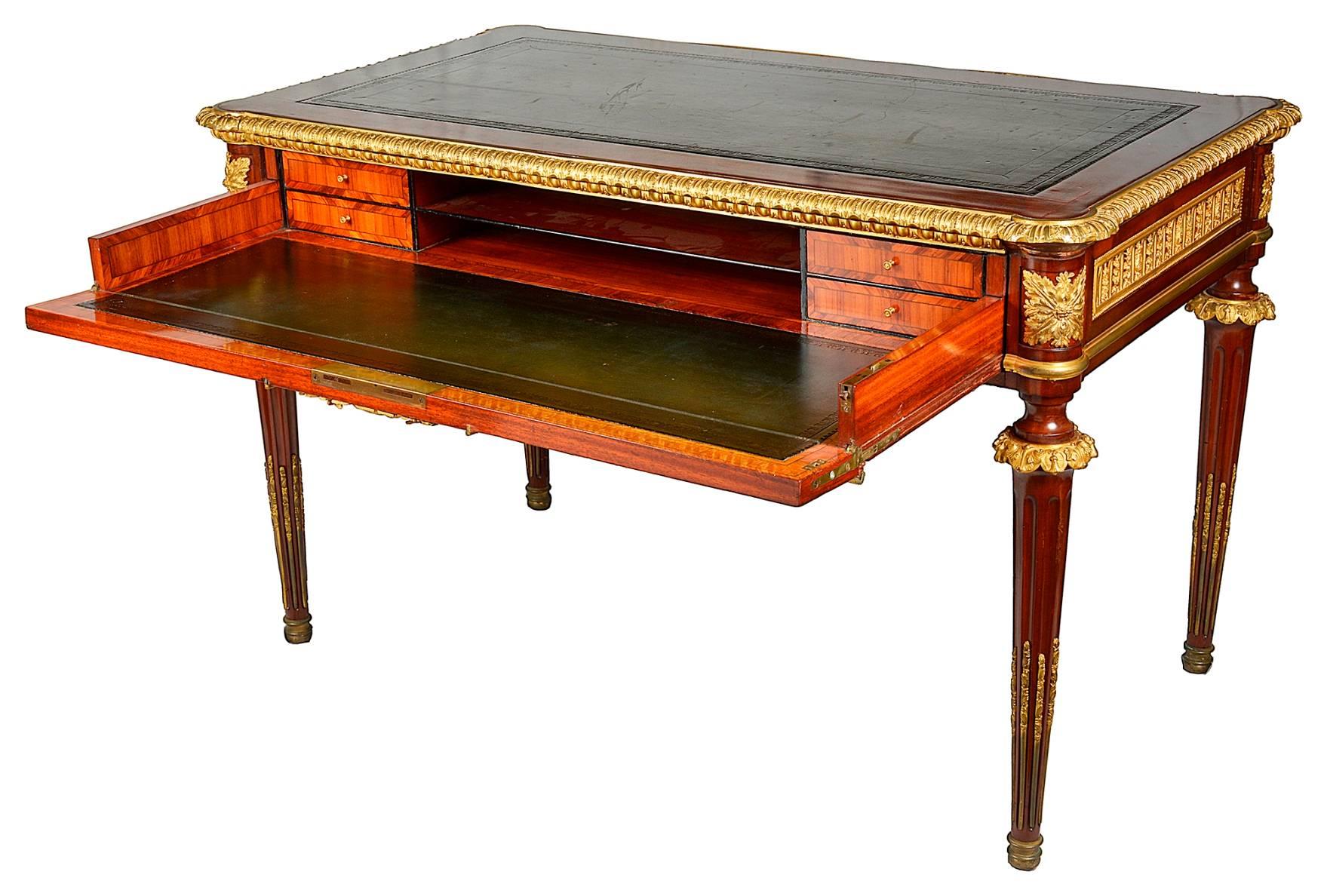 A very good quality 19th century Louis XVI style mahogany bureau plat. Having an inset leather top, wonderful gilded ormolu mounts, the single frieze drawer having a drop front, opening to reveal a secretaire with inset leather top and compartments