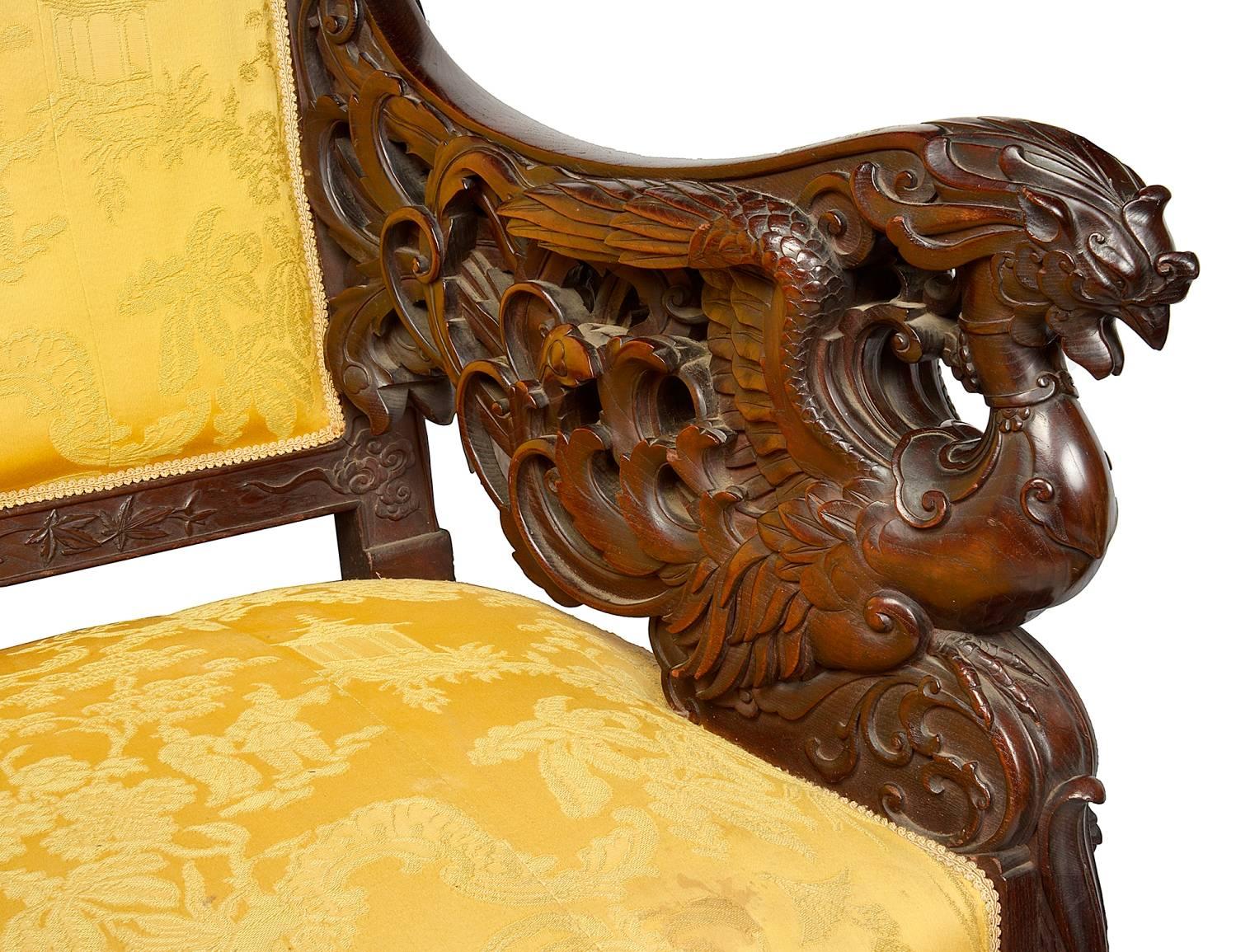 A beautiful 19th century Japanese sofa, having carved classical oriental foliate, floral decoration, with mythical dragons to the arms and raised on scrolling cabriole legs.