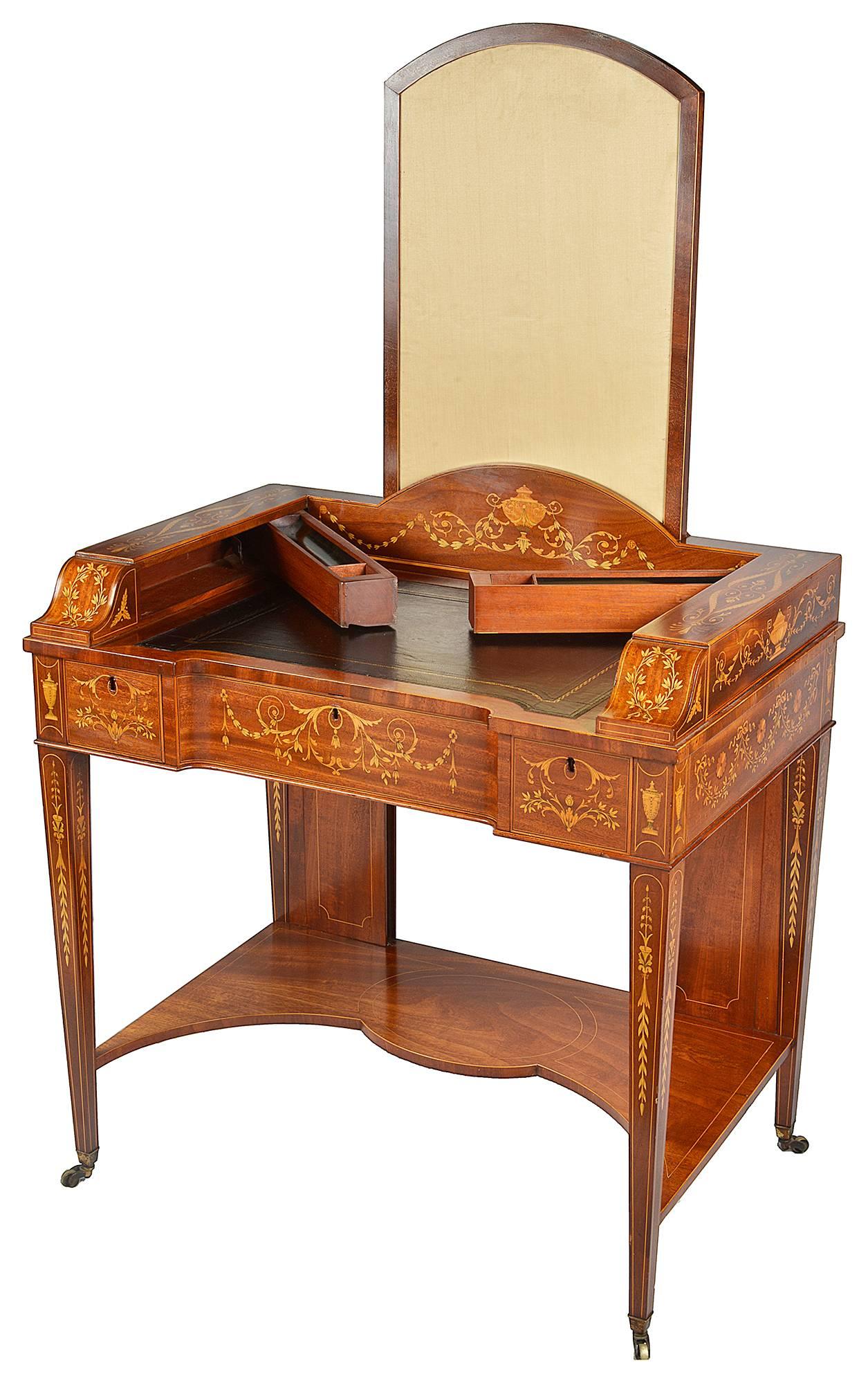 A very good quality 19th Century Edwardian period, Sheraton Revival inlaid desk. Having a fire screen that pulls up, secret compartments that pop out from the sides for ink and pens. An inset leather top, three frieze drawers, each with inlaid