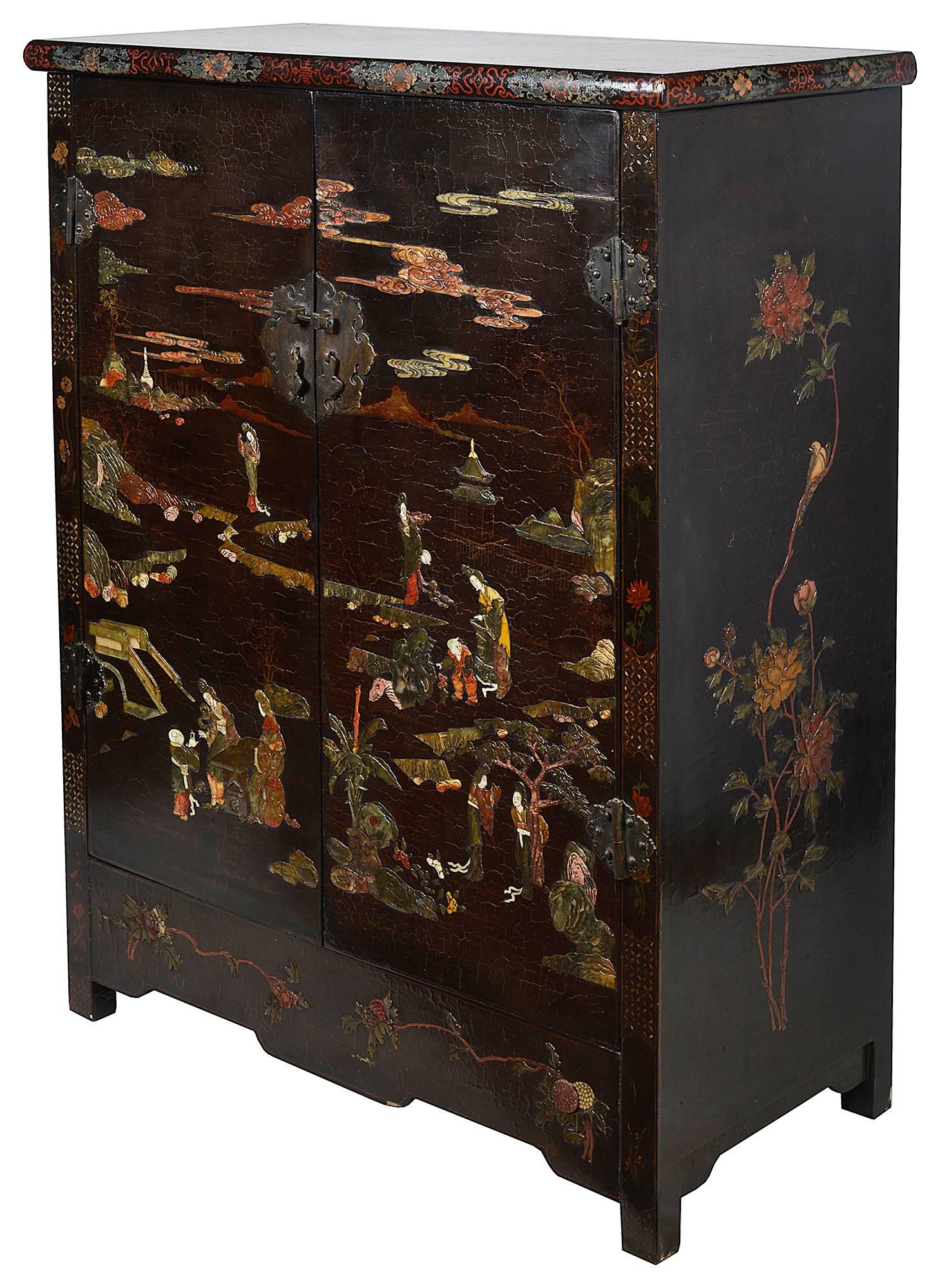 A rare pair of early 19th century Chinese Coromandel lacquer side cabinets, each inlaid with soap stone, depicting classical Chinese scenes set on a lacquer background.
Early labels showing they were exhibited at the Brighton Pavilion.