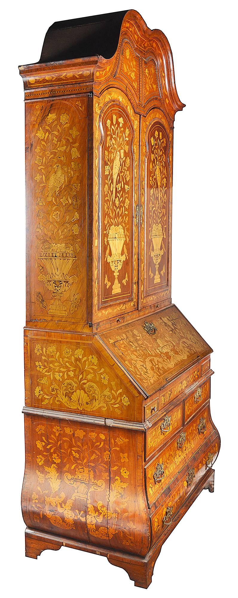 A very good quality 18th century Dutch marquetry inlaid bureau bookcase. Having a double dome top cornice, two panel doors, a fall front and bombe shaped base. The wonderfully bold and fine quality inlaid marquetry detail of flowers, birds and