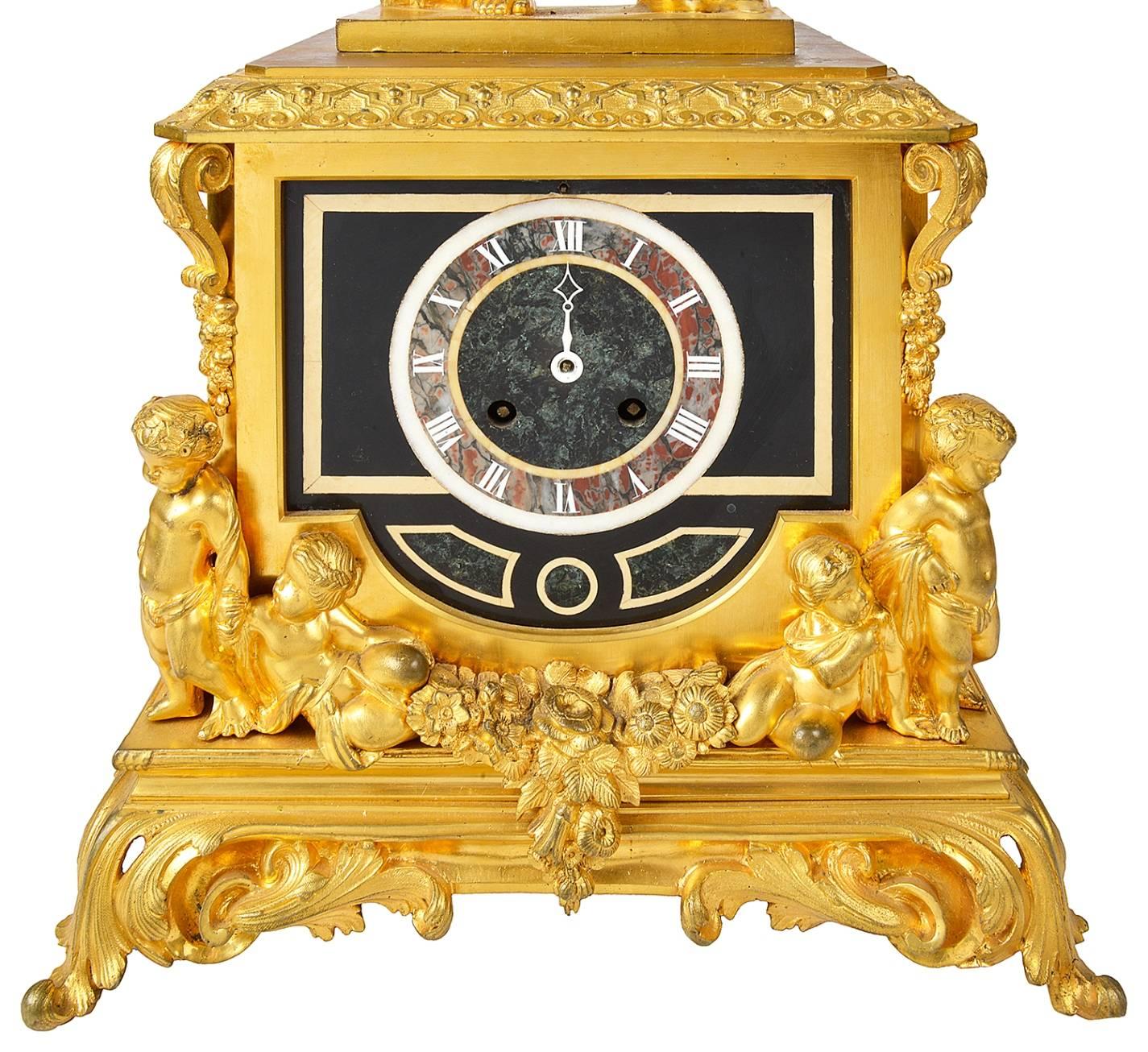 A very good quality 19th century gilded ormolu Louis XVI style clock garniture. The clock having a Classical Roman soldier above a square section clock with inlaid marble clock face and supported by cherubs with swags.
The pair of candelabra each