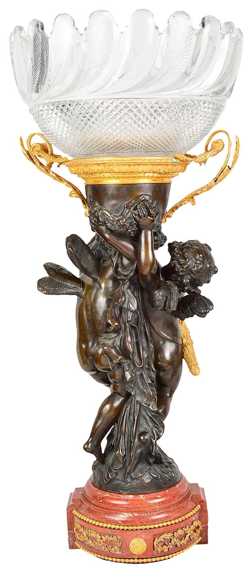 A wonderfully impressive 19th century bronze, gilded ormolu and cut glass centrepiece. Have a cut glass bowl with gilded ormolu handles, supported by a pair of winged cherubs and raised on a rouge marble base with ormolu mounts.
Signed; A. Moreau.