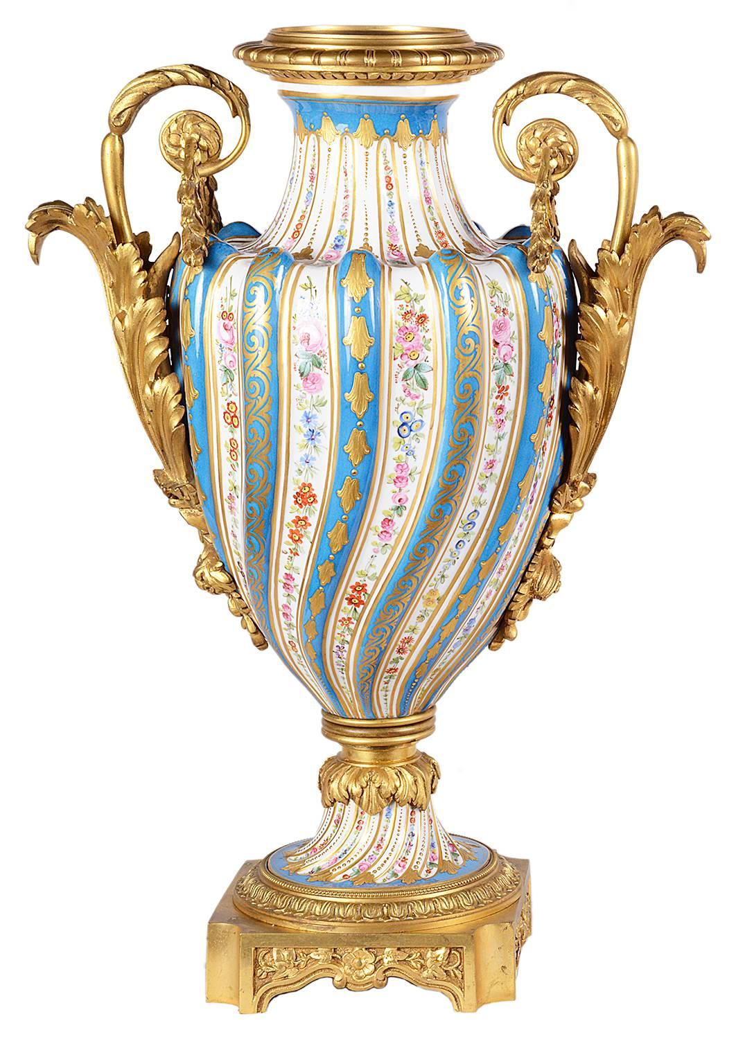 A fine quality pair of 19th century French 'Sevres' style vases, having gilded ormolu mounts, a twisted, fluted, ribbed form with turquoise border and floral decoration.
We can arrange for this pair of vases to be wired as lamps.