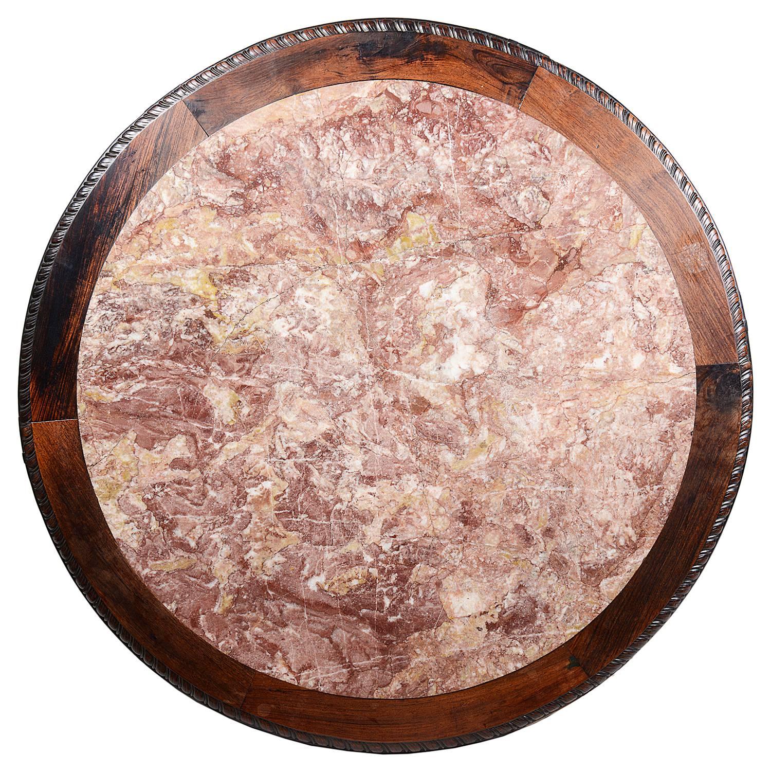 A good quality Chinese, 19th century hardwood centre table. having an inset marble top. Carved foliate decoration to the frieze. Raised on a central pedestal with carved Chinese figures amongst trees and flowers and four carved feet.