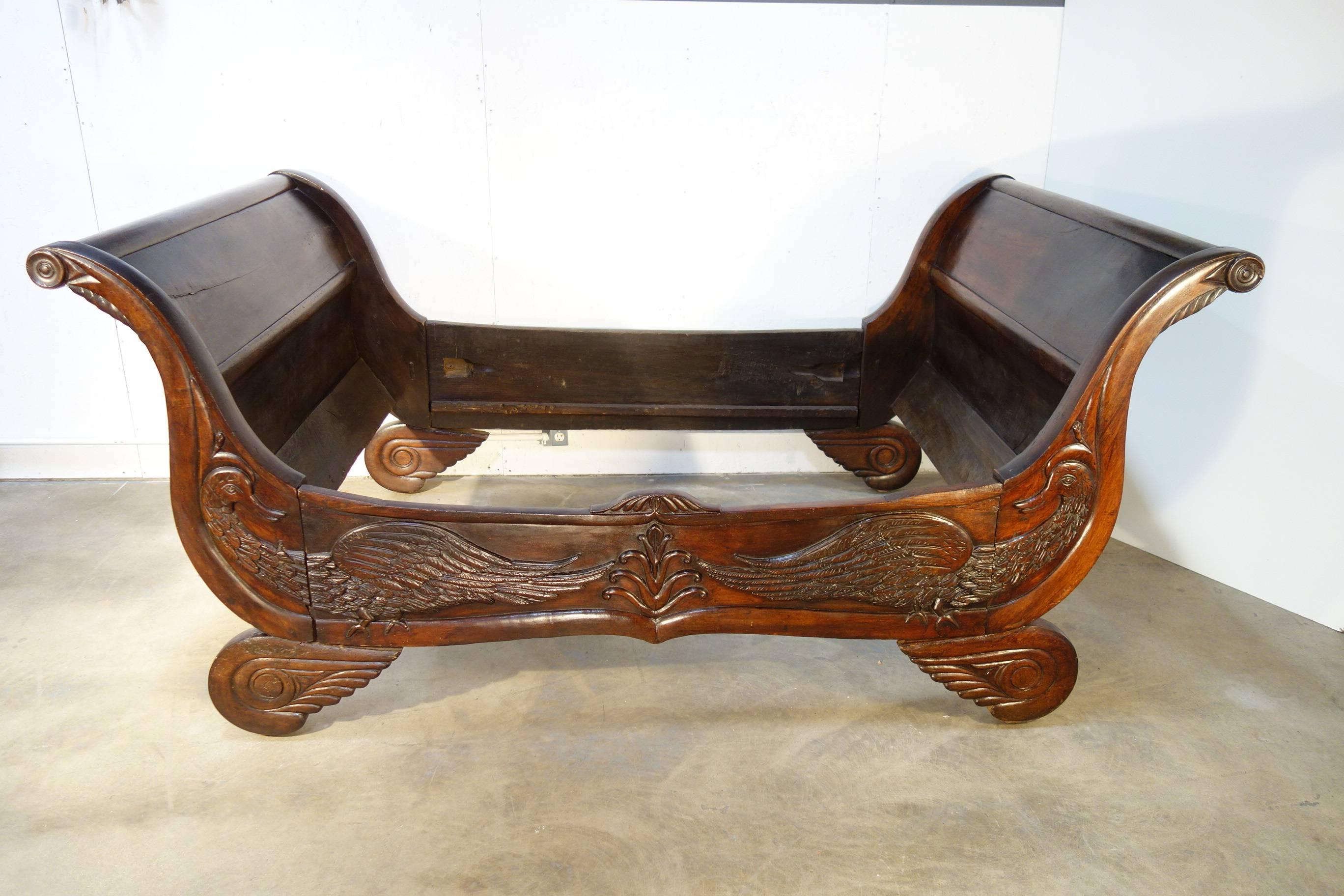 Italian antique daybed, elaborately hand-carved with swans. Solid dark walnut. Piedmont, circa 1820. Wonderful details on swans and foot. Only the front face it is carved, the back it is plain and unfinished. There are couple of old restoration on