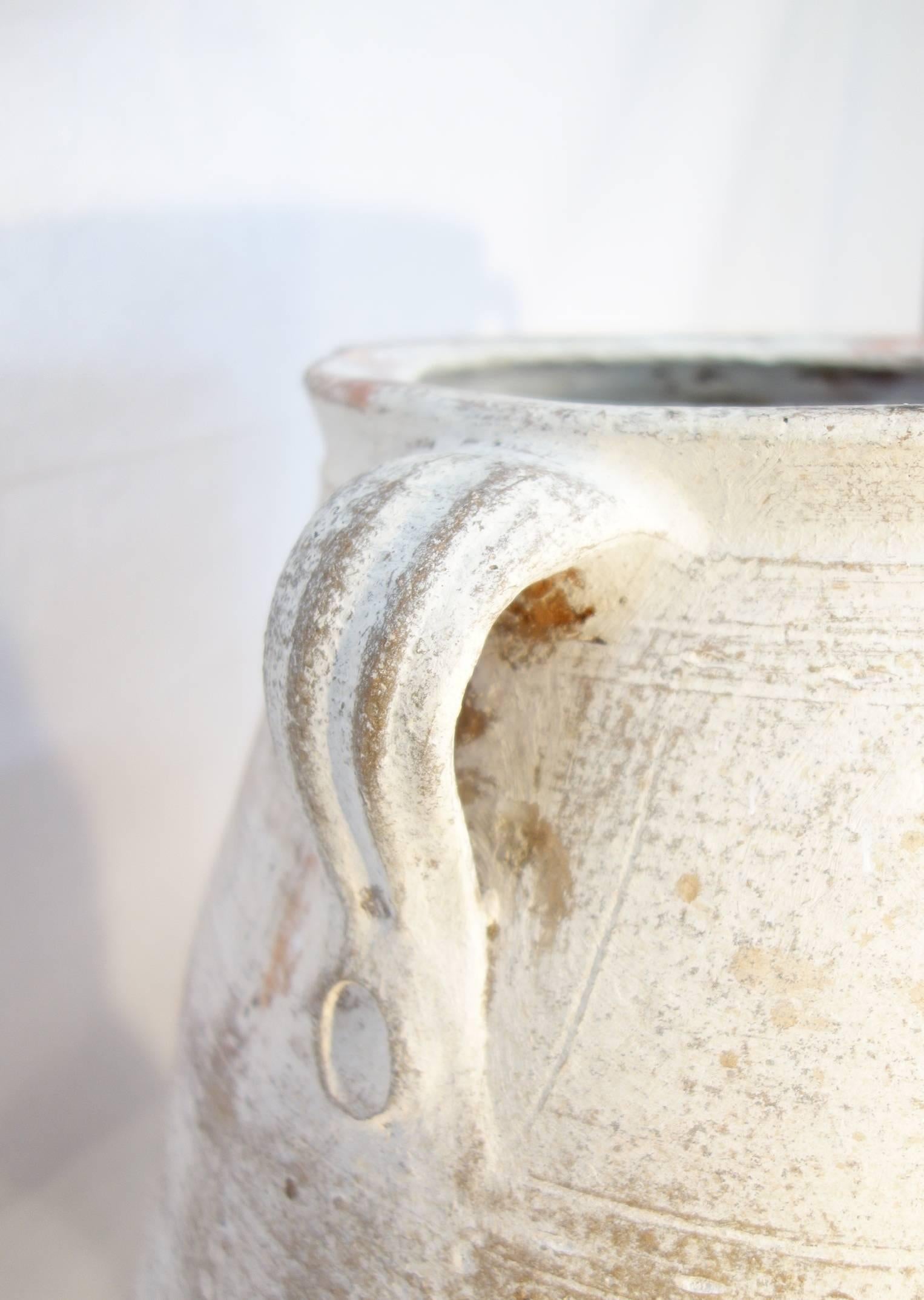 Mediterranean antique pottery Amphora, wonderful white lime patina, it was once used as storage and shipping jars for wine, olive oil, or various types of vegetable.

Dimensions are 26