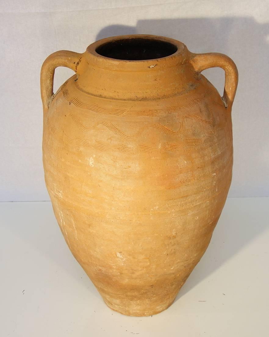 Mediterranean antique pottery amphora, present a sort of graffiti decoration on the top part. It was once used as storage and shipping jars for wine, olive oil, or various types of vegetable, circa 1820.

Measures: 22