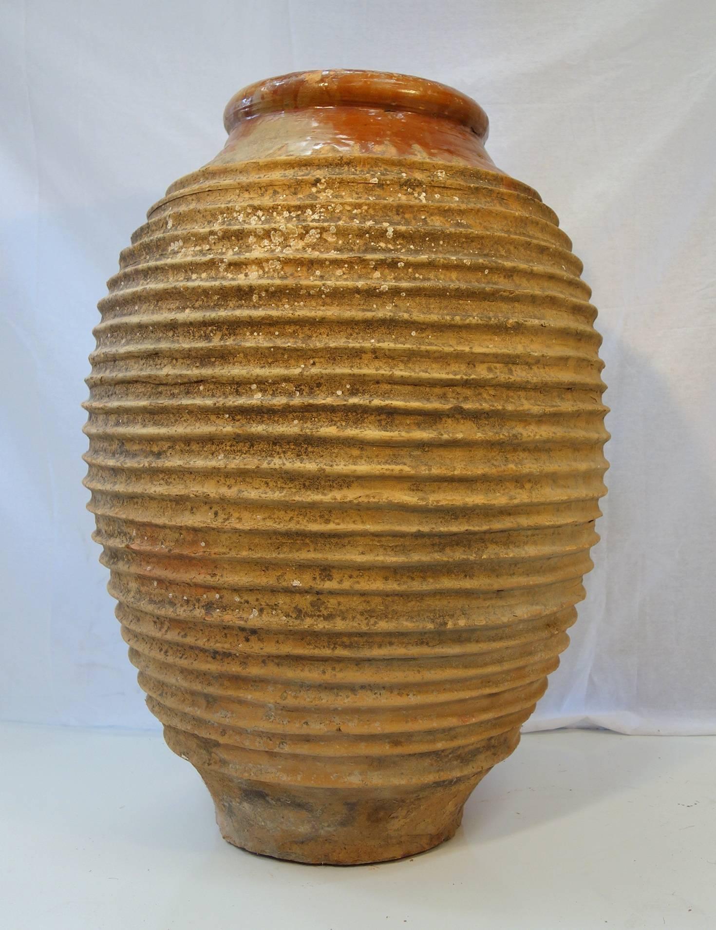Peloponnesian Koroni jar naturally weathered into a beautiful patina with lichen. Around the top neck the clay present some beautiful ocra orange glaze.
Typical 