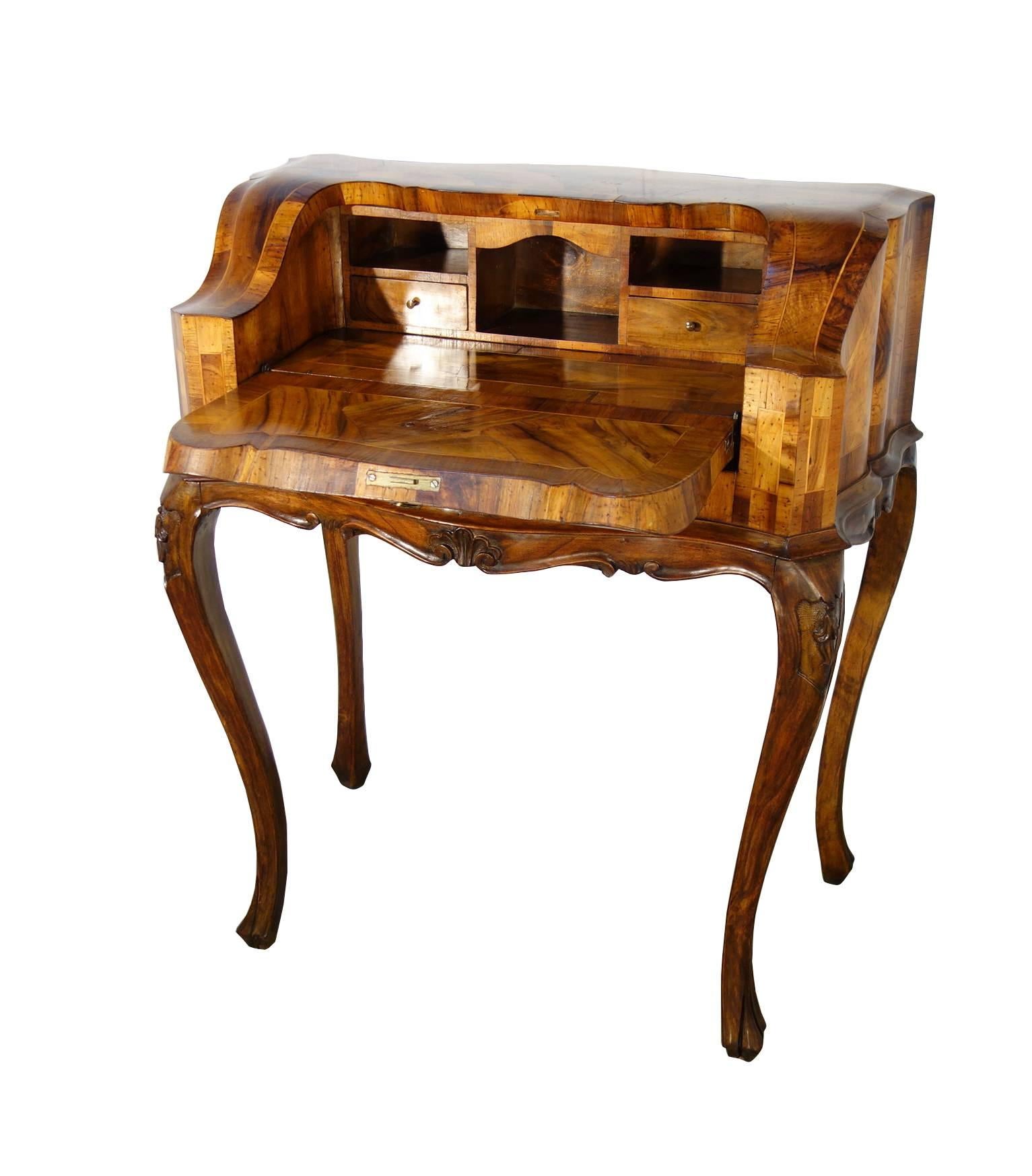 Venetian, Louis XV style, serpentine shape, lady desk; beautiful end-cut walnut burled veneer; cabriole legs; drop front opens concealing two little drawers and compartments.