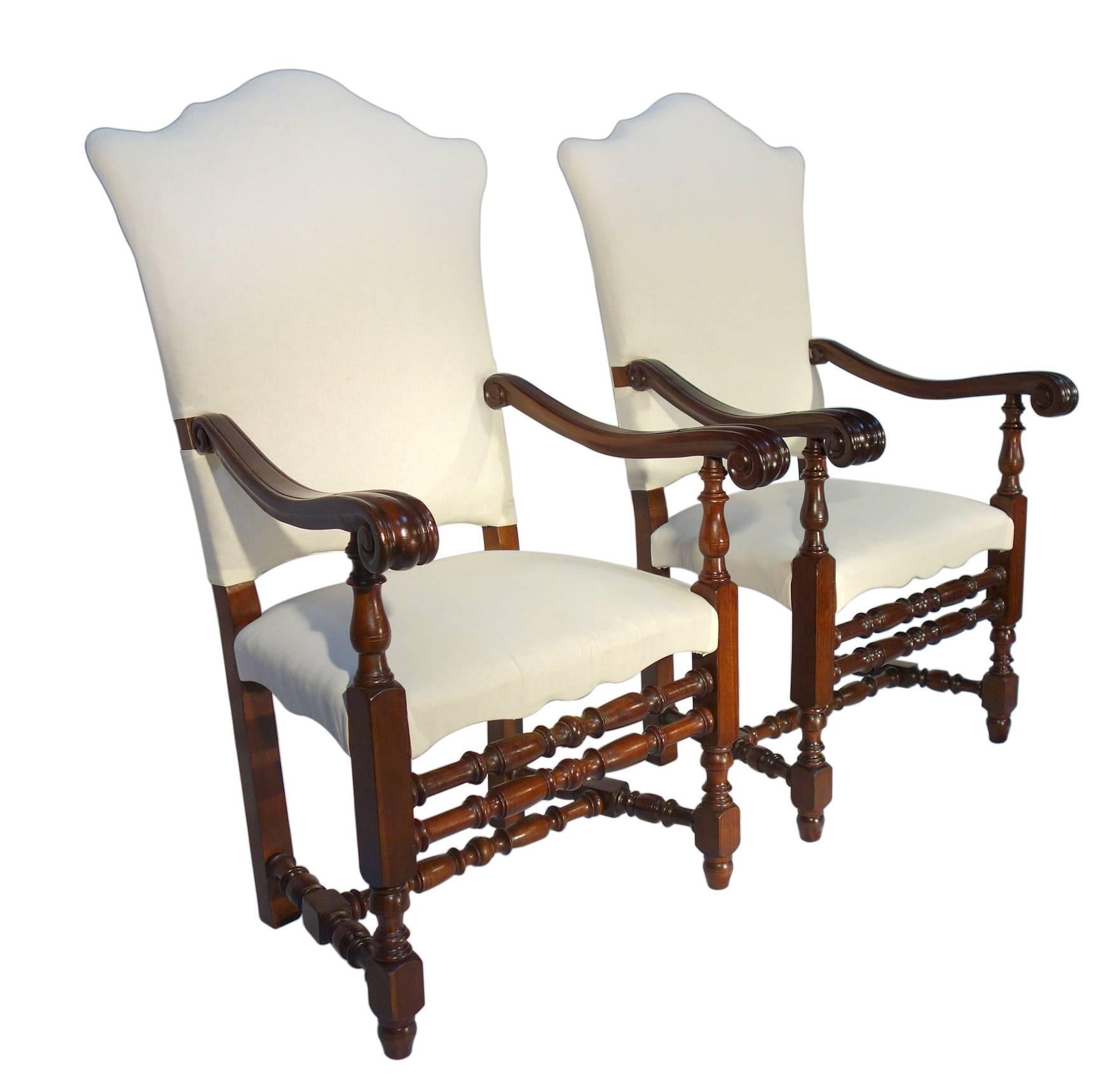Stately Renaissance, Lombardy, late 17th century style walnut armchair pair, with carved arms and turned wood elements for an elegant, sophisticated dining or occasional setting. Re-upholstery is necessary. Available two pairs.

Measures:
