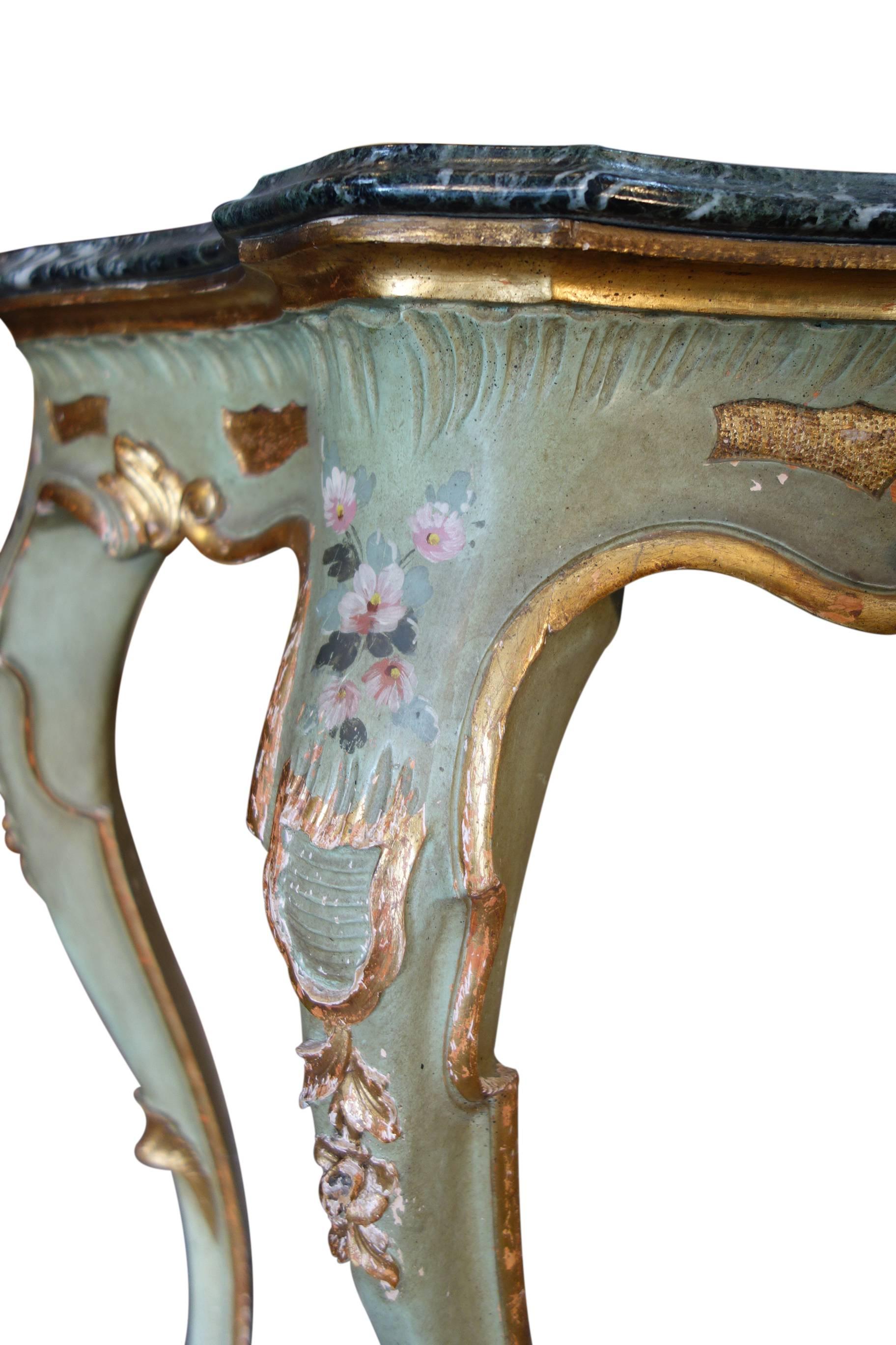 Exquisite Venetian hand-painted 18th Century style console table, circa 1880. Dynamic silver deposits in serpentine marble. Soft gold gilt & green patina with floral triumph, hand carvings.

Measures:  47