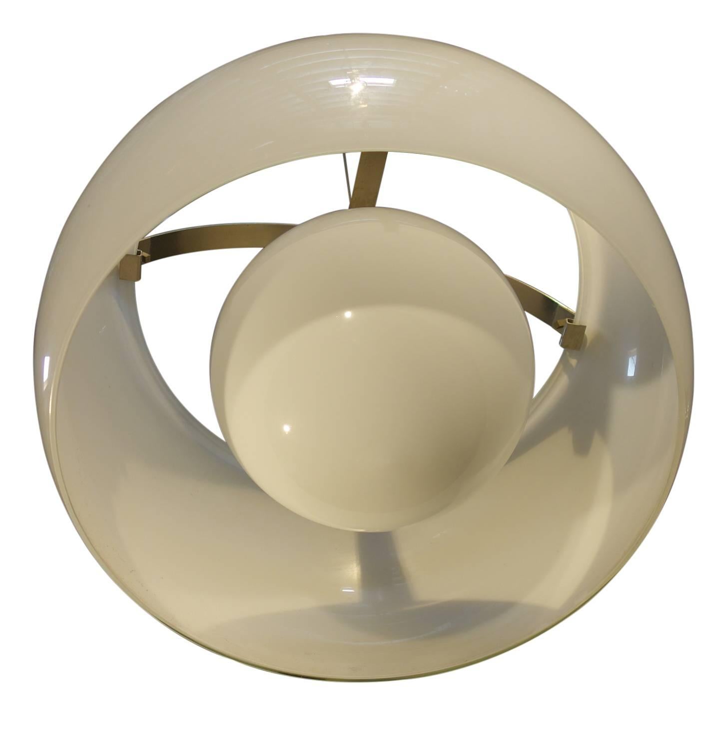 Italian Mid-Century chandelier called Omega, designed by Vico Magistretti and first produced in 1961 in Milan for Artemide. Large white glass shade shield with a smaller round globe suspended inside from burnished chrome banding support fixture.