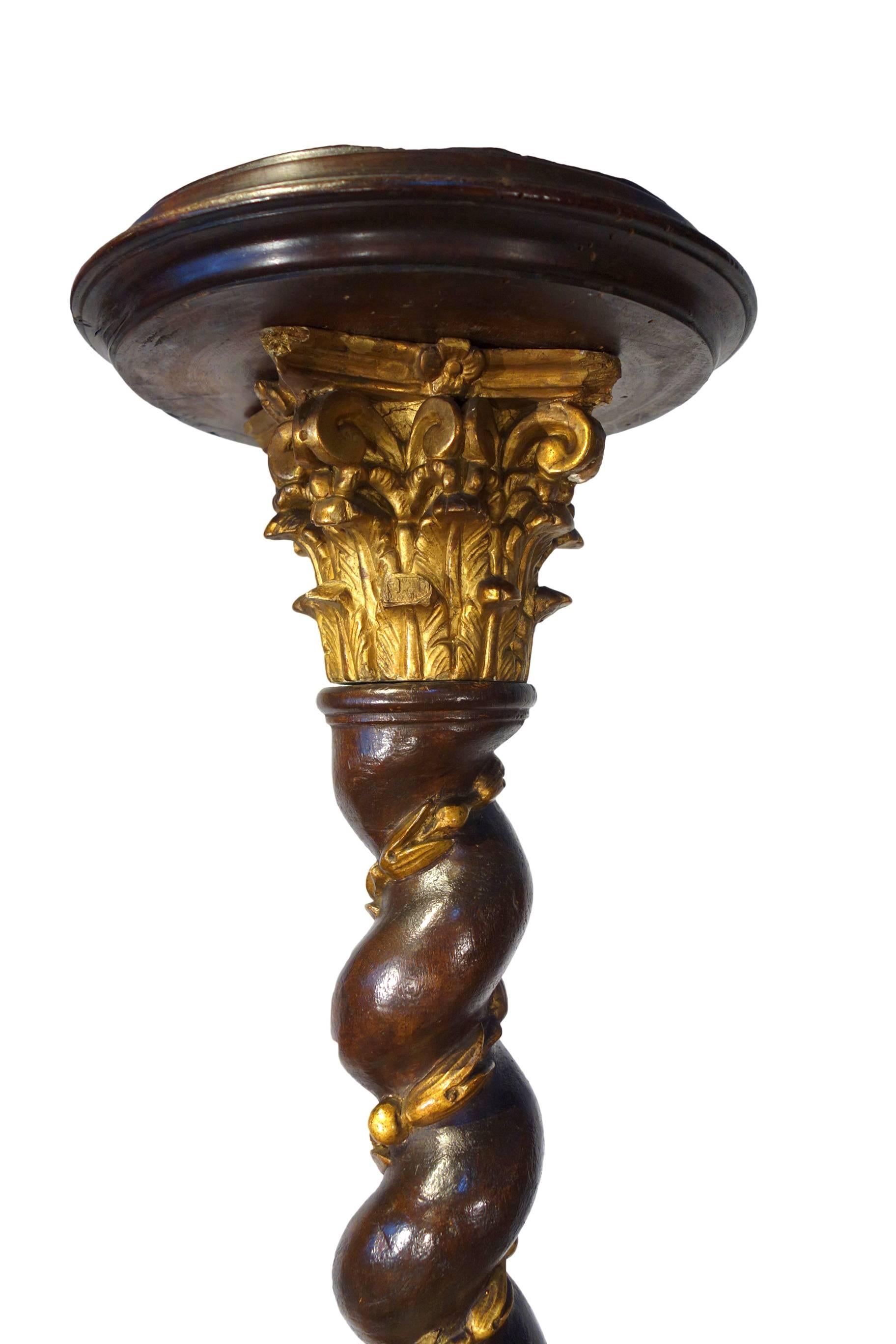 Spectacular, ornately carved walnut candle torchiere pair with gilt details, exquisite Corinthian capitals, spiral columns with acanthus leaves and berries, supported by architectural, triangular bases. Romantic period, circa 1820.

Dimensions: