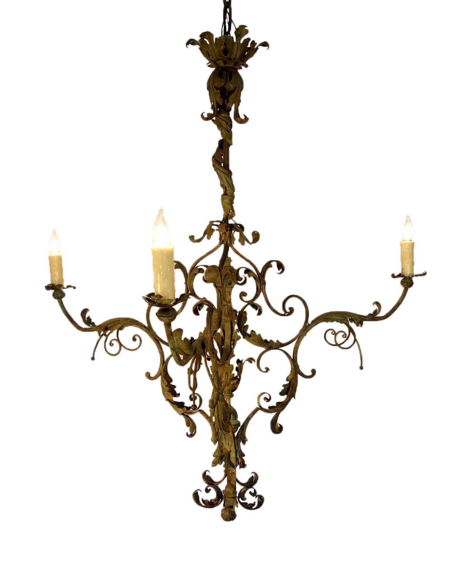 One of a kind Tuscan wrought iron green three arms chandelier. Fantastic green patina hand-forged iron leaf and twisted floral motifs create a piece of art. 

UL newly rewired. 

Measures: 43" W x 50" H, plus 29" chain.