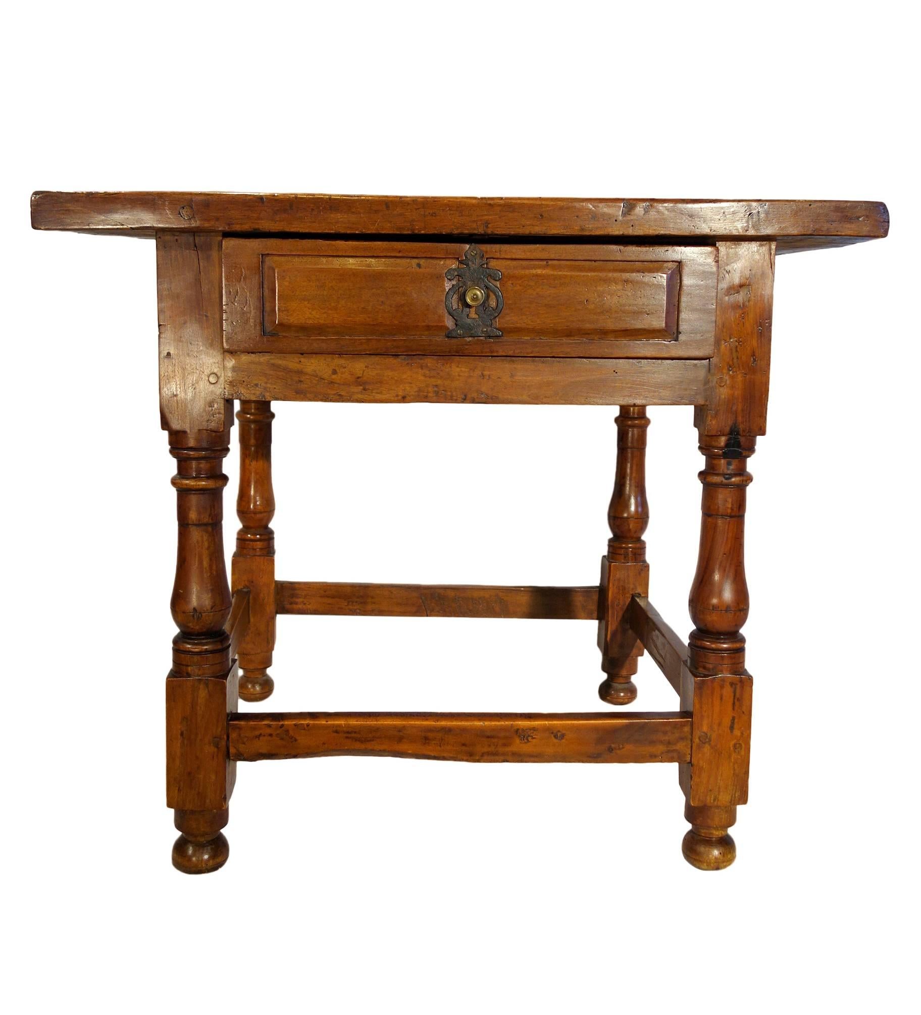 Handsome and rustic, 17th Century Tuscan style, solid walnut occasional table with one center drawer and square framed base with crafted legs.

Measures: 34.25