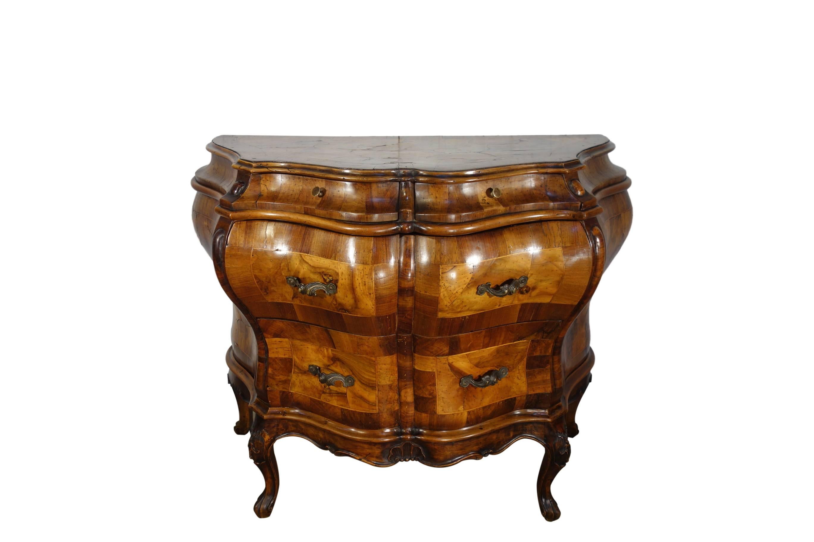 Lovely and striking commode of carved walnut solids, gorgeous burled veneers and inlays, featuring two upper small drawers and two larger lower drawers with fancy bronze hardware, early 20th Century Baroque Rococo Revival.

Dimensions:  39