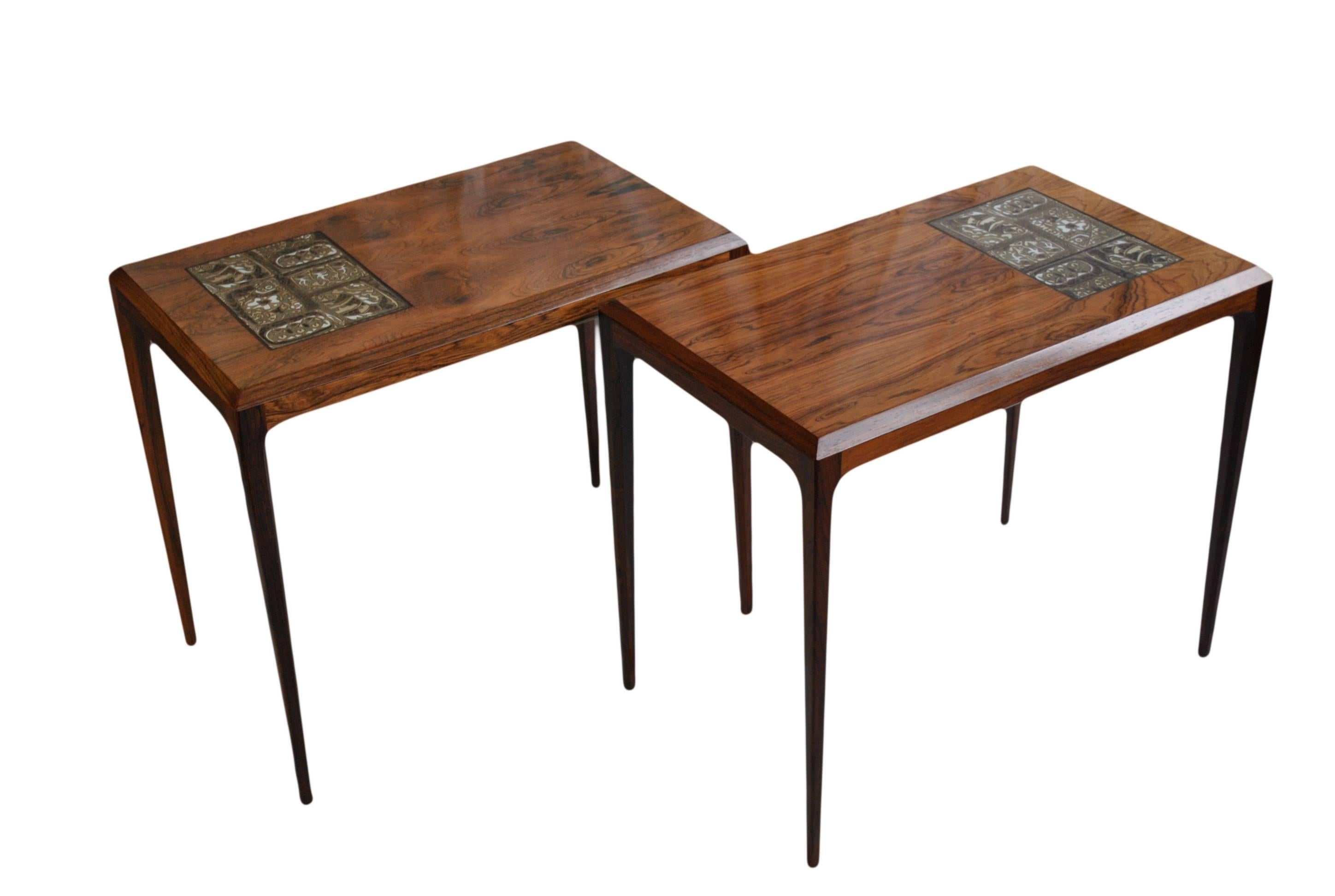 Beautiful matching pair of end tables or nightstands designed by Johannes Andersen for CFC Silkeborg. Produced in the early 1960s, Denmark. Superb rosewood with inset Royal Copenhagen tile detail.
Wonderful condition.