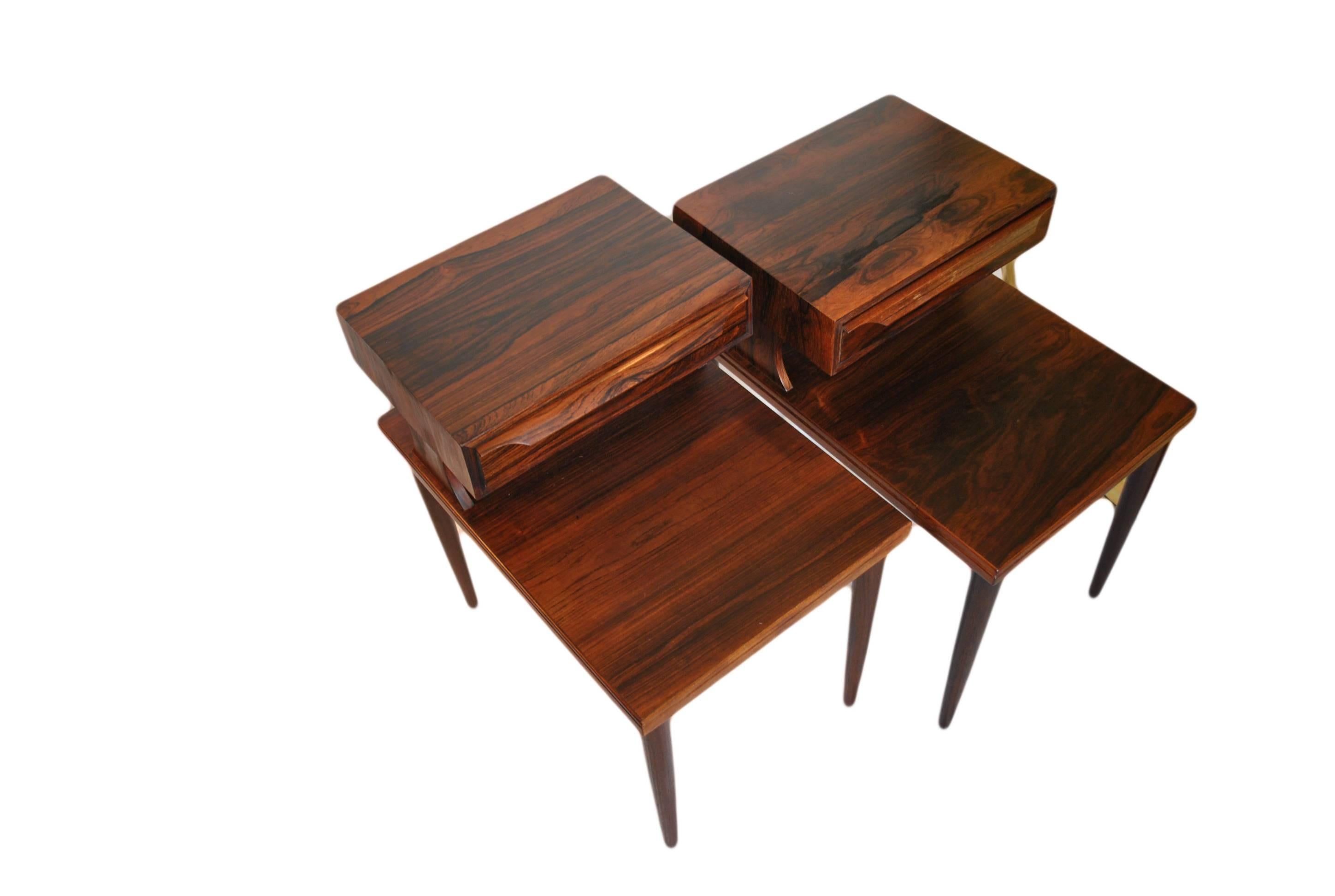 Beautiful pair of unusual two level nightstands. Produced in Denmark during the 1960s. Lovely grained rosewood and in super condition.
The legs unscrew for extra safe shipping.
 