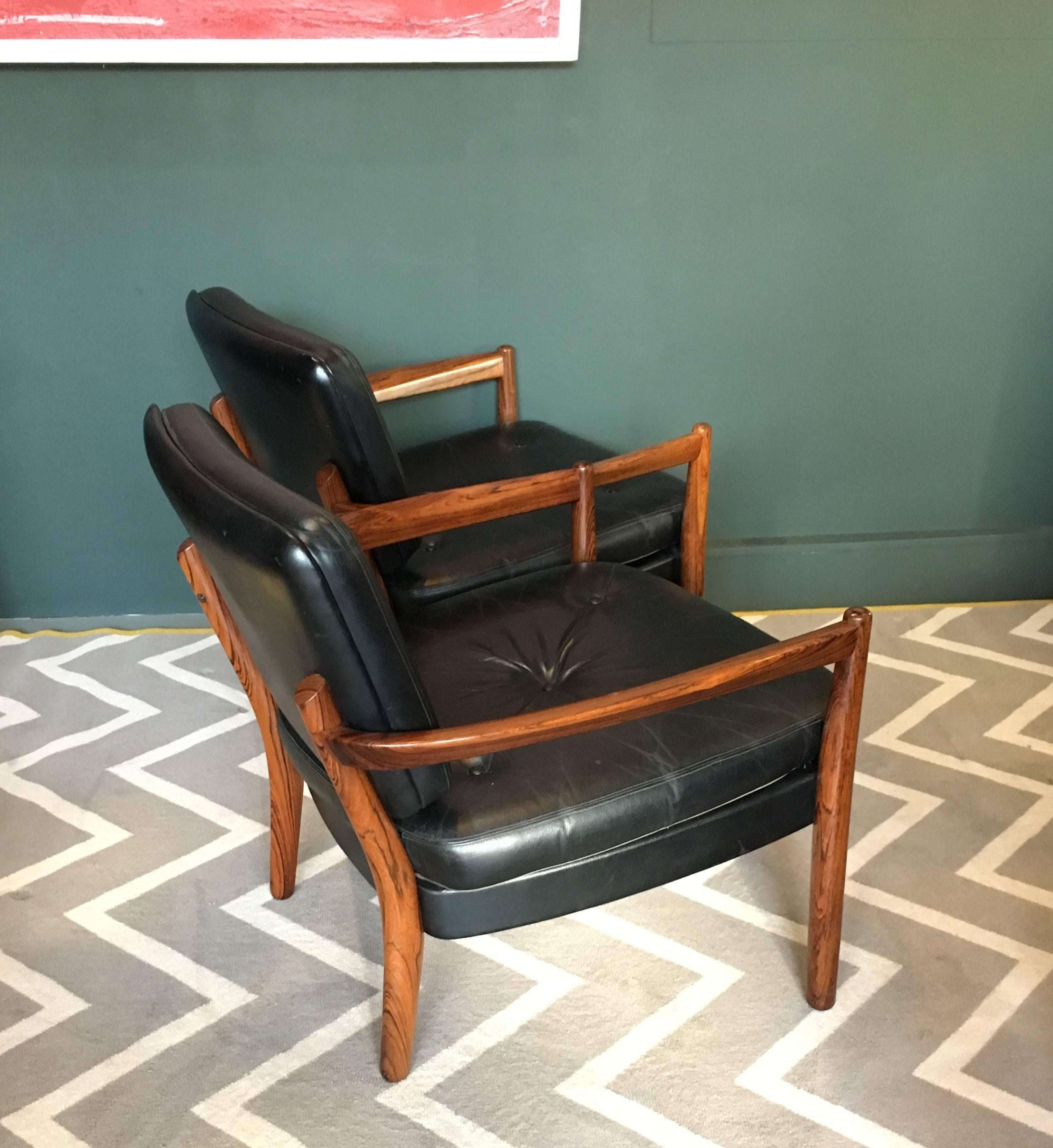 Highly unusual matching pair of Scandinavian lounge chairs. Finest quality rosewood frames upholstered in original black leather. Produced in the early 1960s in Norway. Superb and unusual design style and construction.
We can reupholster if