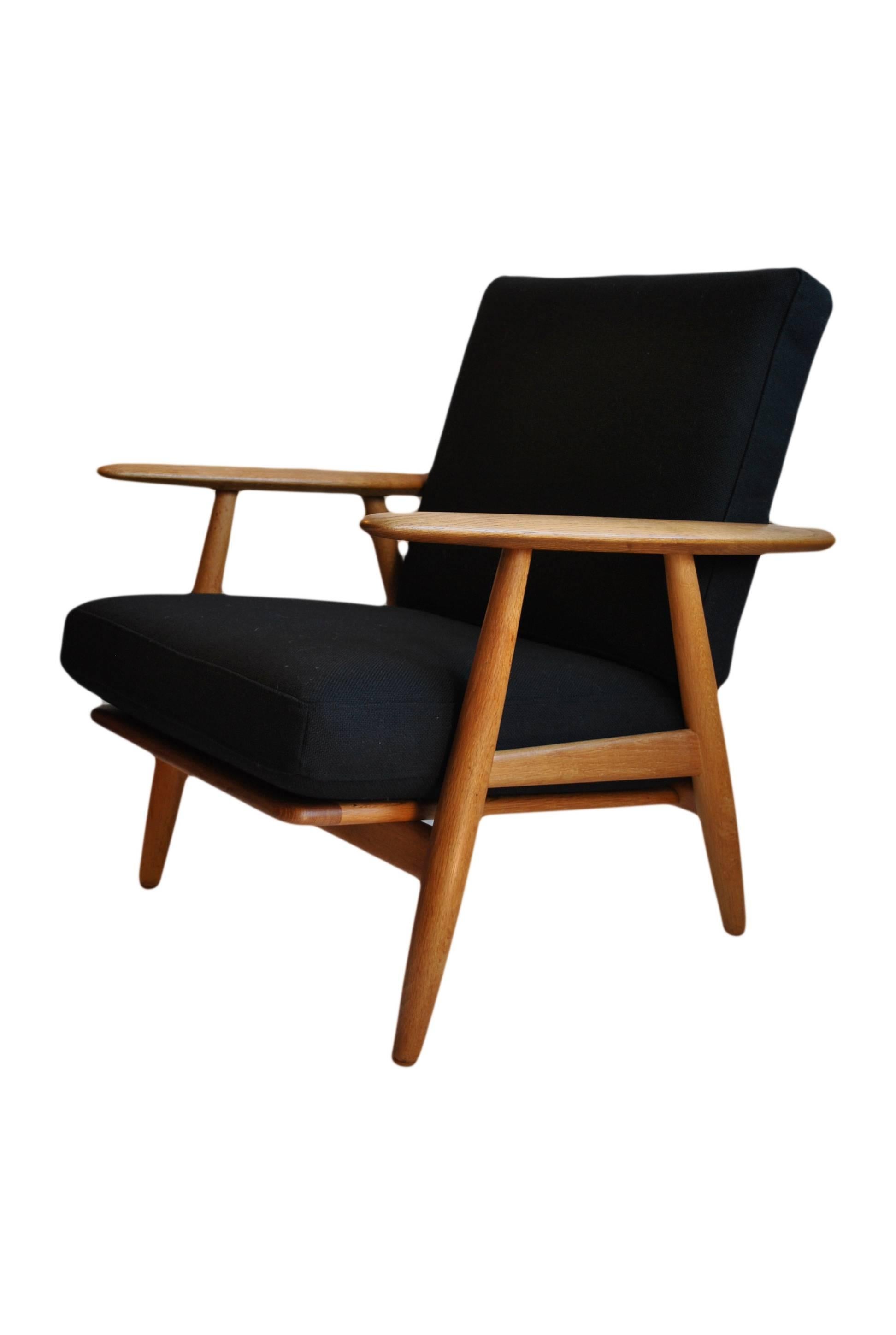 Model GE240 Hans J Wegner 'cigar' chair. Early GETAMA version in Oak. New black wool/cotton weave upholstery. Other upholstery available.
Makers stamps to underside.