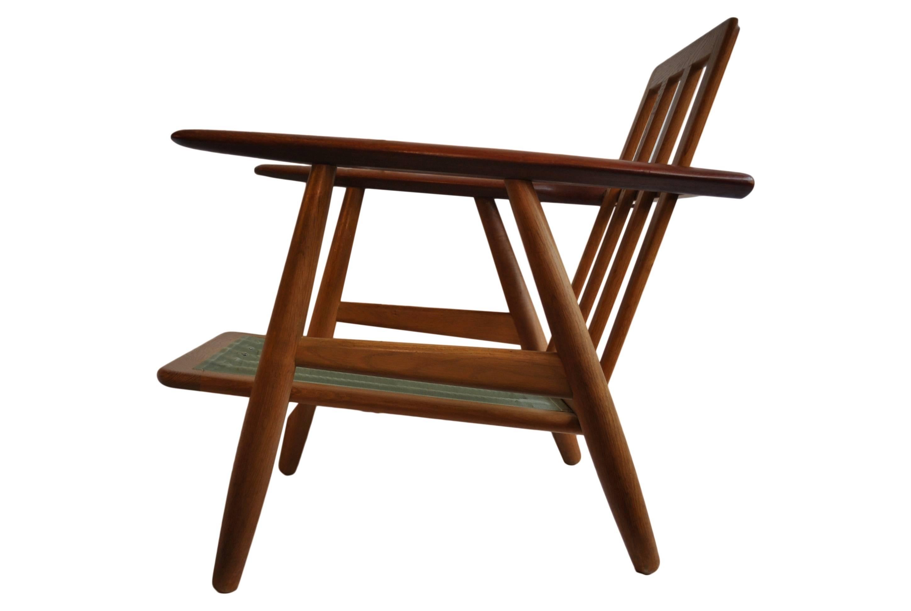 Oak frame with teak arms Classic GE240 'cigar' chair by Hans J Wegner for GETAMA.
Denmark, circa 1955.
Original metal sprung cushions which we can reupholster in any fabric or leather. U.S shipping available.
 