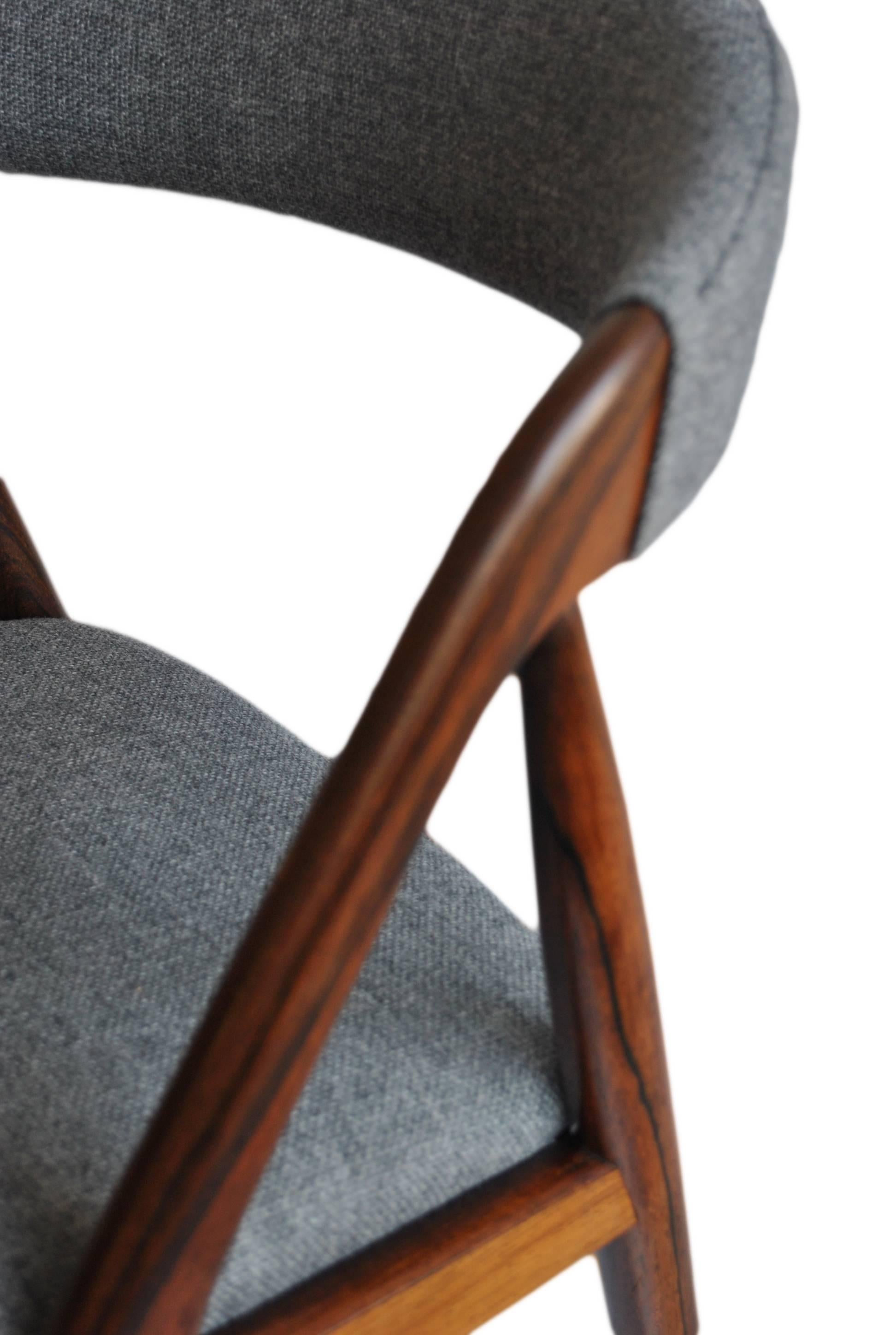 Kai Kristiansen Classic dining chairs in Brazilian rosewood with new Danish wool/cotton weave upholstery. Others available. 
1960s originals, repolished. More in stock and matching circular extending table available.