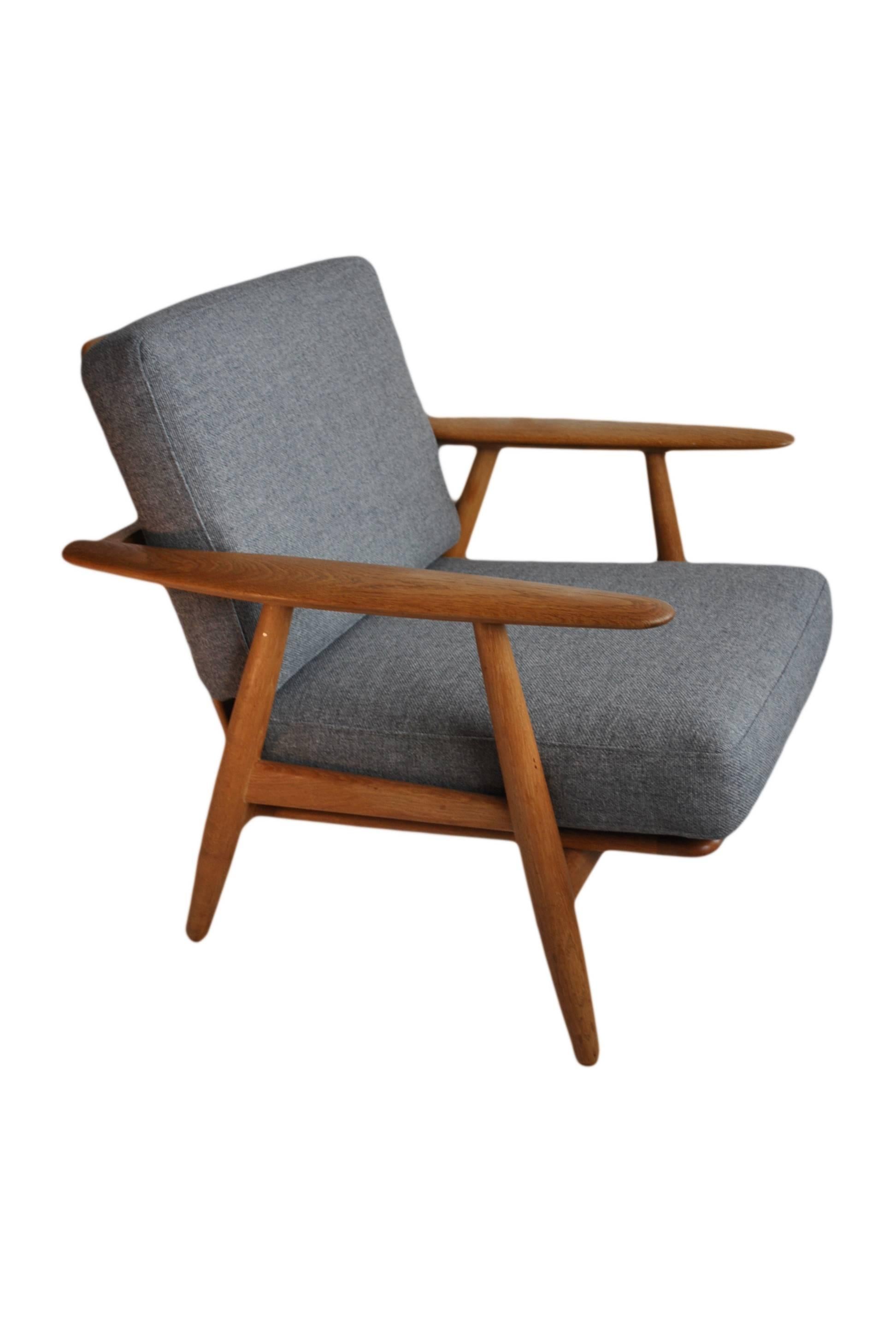 Lovely oak version of Hans J Wegner cigar chair model GE240. Produced by Getama, Denmark in the late 1950s. Great example with new wool weave upholstery.