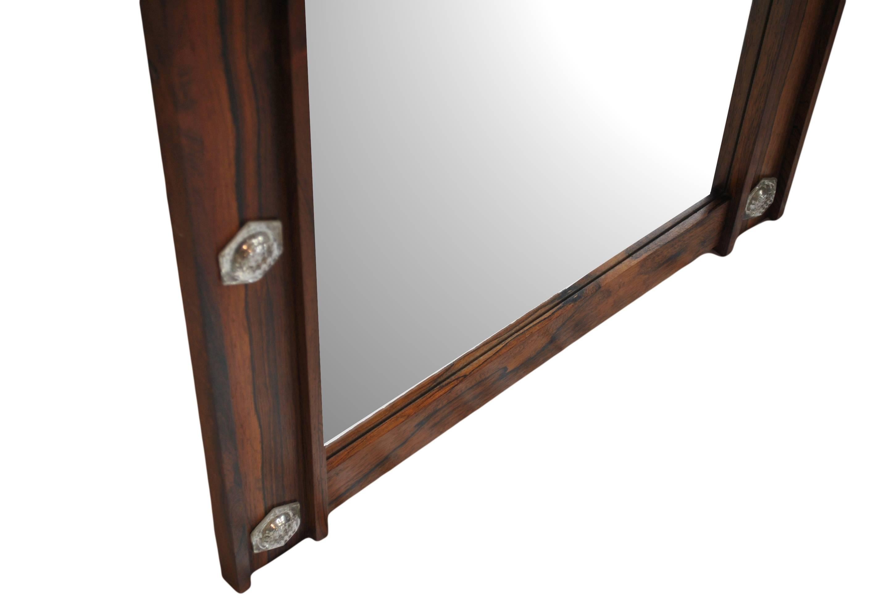 Wonderful large Danish Midcentury Mirror. Constructed from santos Rosewood with handmade glass inserts. Circa 1960.
Wall fixings to the rear.