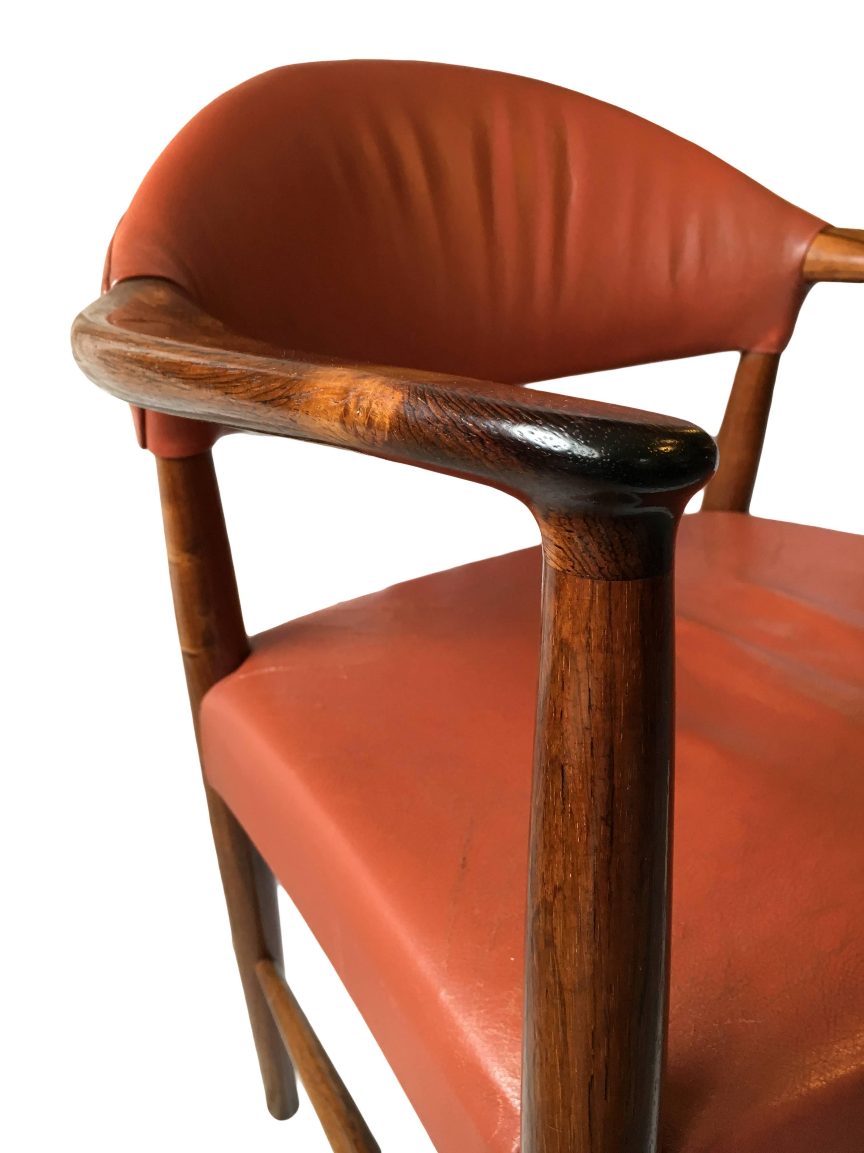 Terrific rosewood armchair designed by architect Kurt Olsen and produced by SM Mobler. Aged red/brown leather. Re-upholstery available, Denmark, circa 1960.