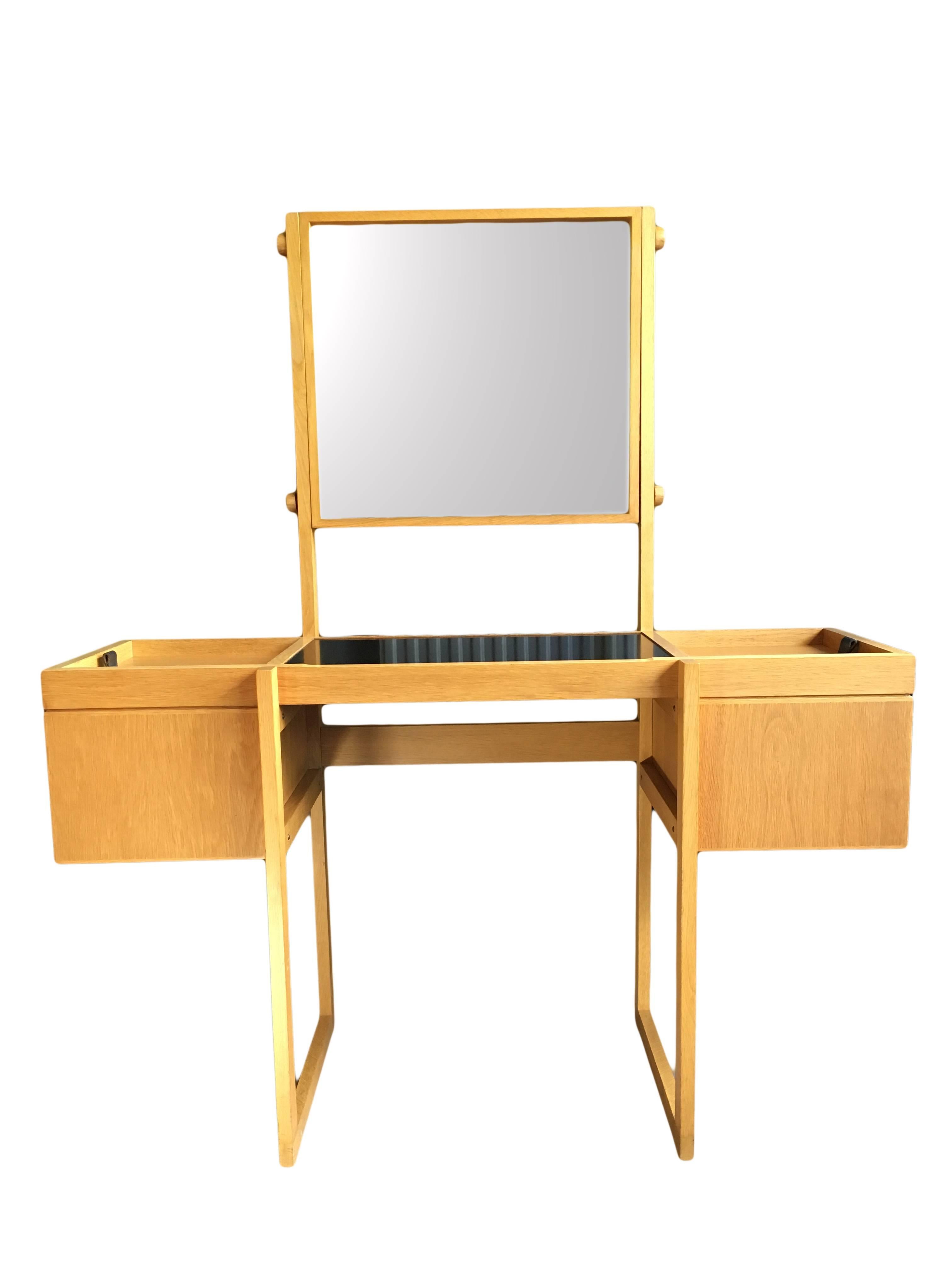 A unique Mid-Century dressing table or vanity unit produced in Denmark, circa 1960s. Total Scandinavian modernism. Solid oak construction with leather pull handles, black surface and tilt adjustable mirror by means of oak stoppers. Superb condition.