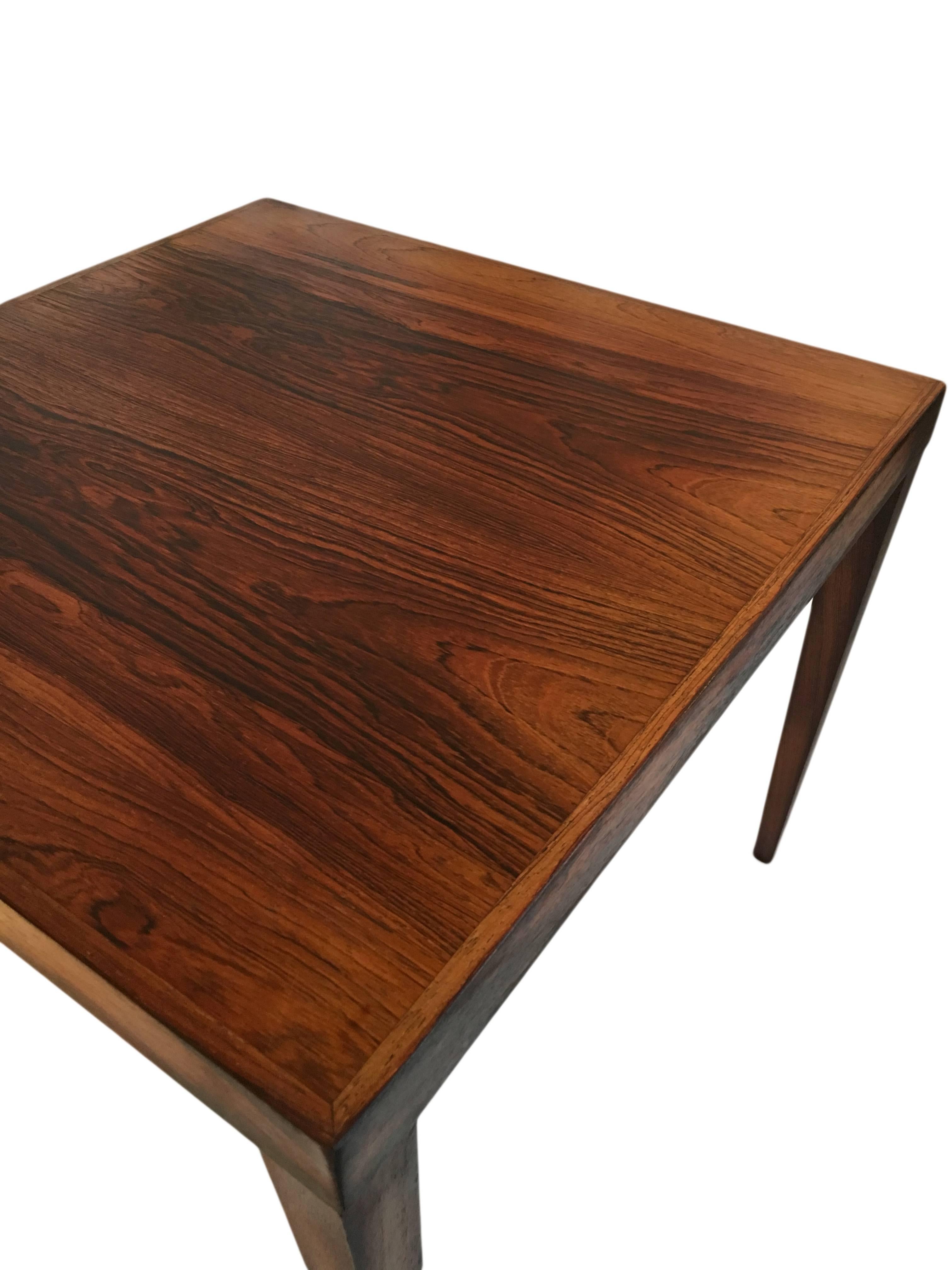 Danish Midcentury coffee table, circa 1960. Simply designed but with wonderful rosewood grain and tapered legs.