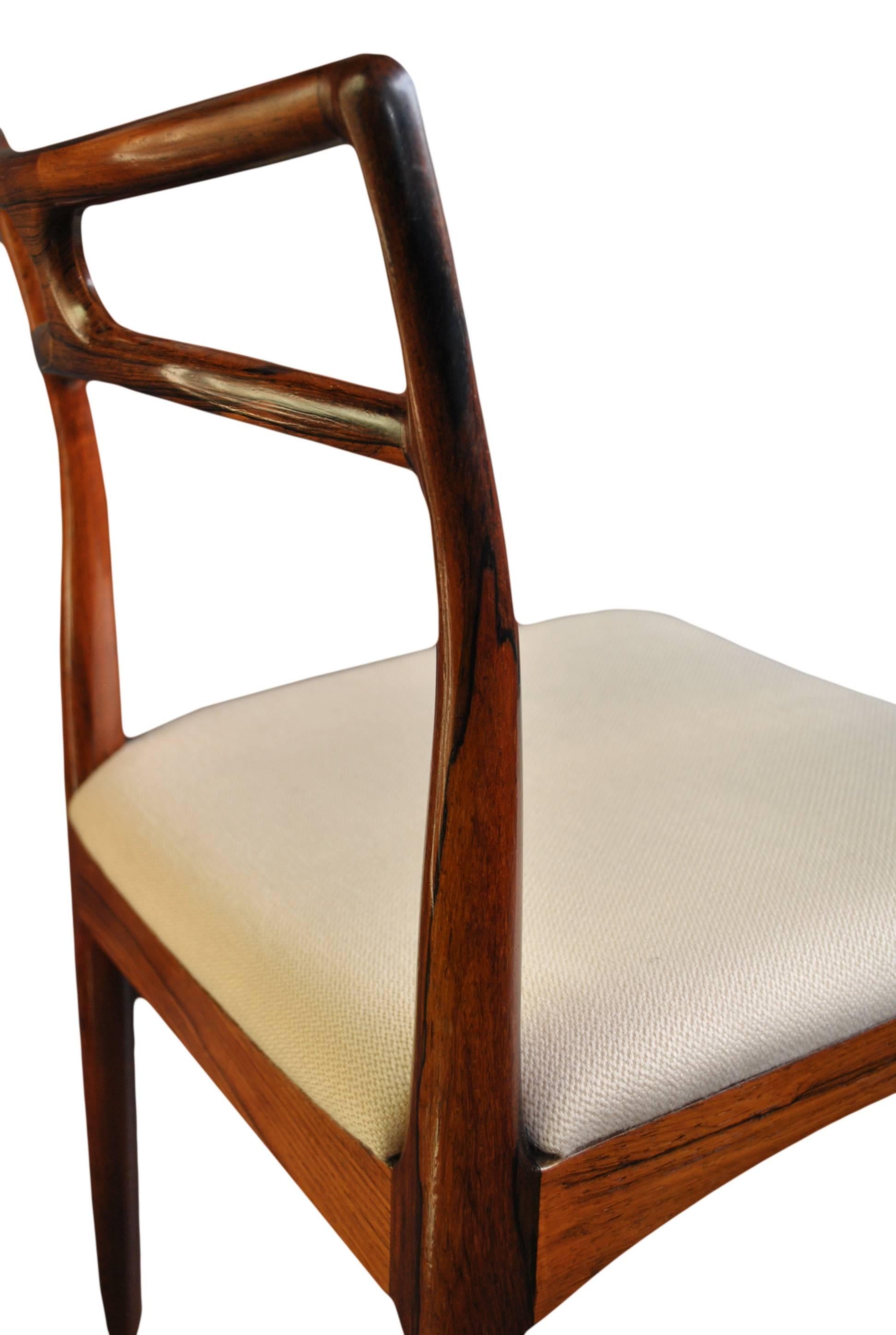 A superb set of Danish Midcentury dining chairs designed by Johannes Andersen for Christian Linneberg in the 1960s. Constructed from the finest Brazilian Rosewood and in wonderful original condition. We will reupholster the seats in any color Danish